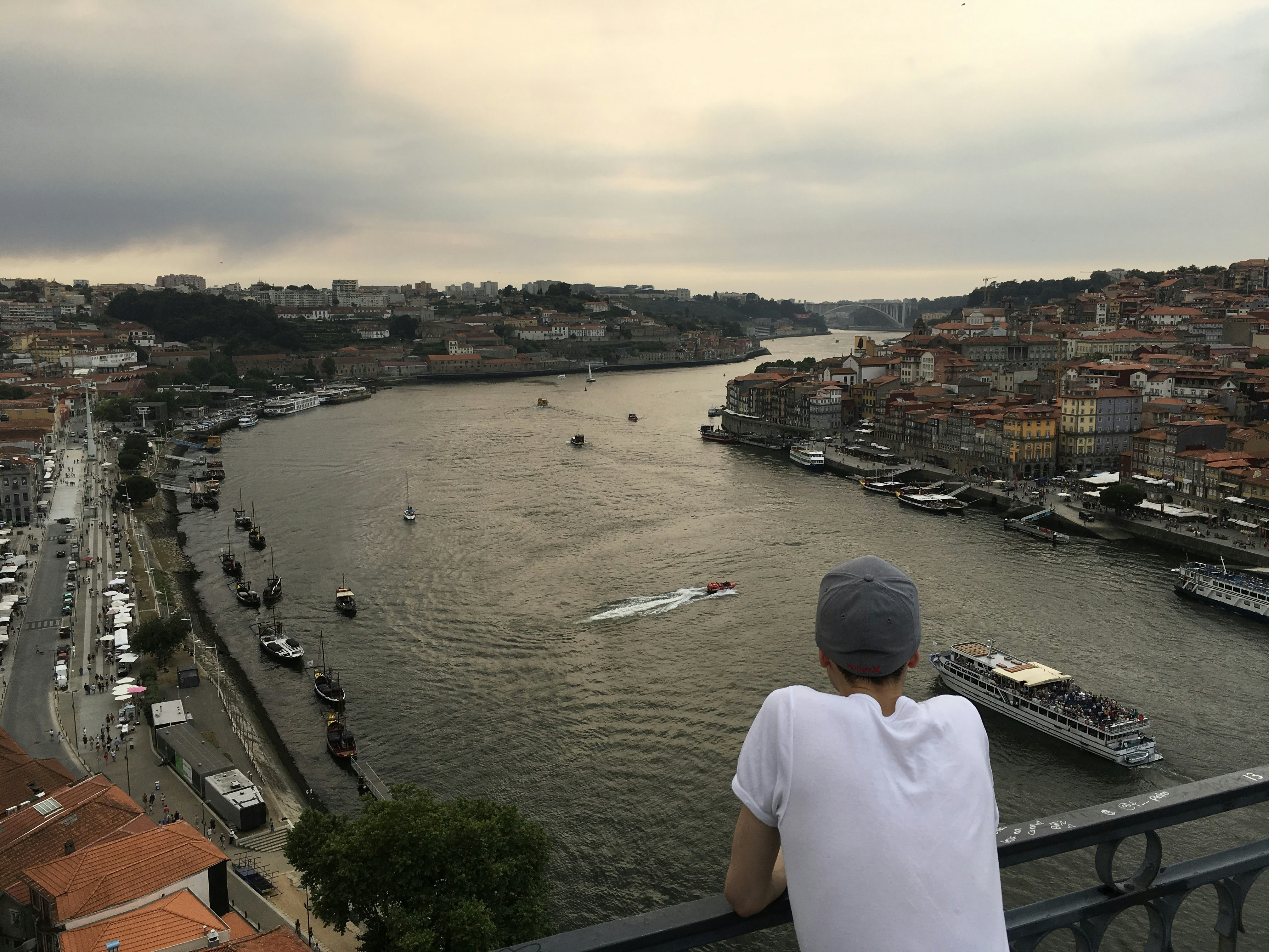 Man looking over river and city buildings