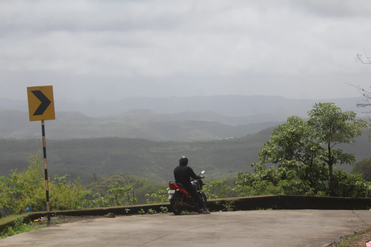 Motorcyclist over misty hills