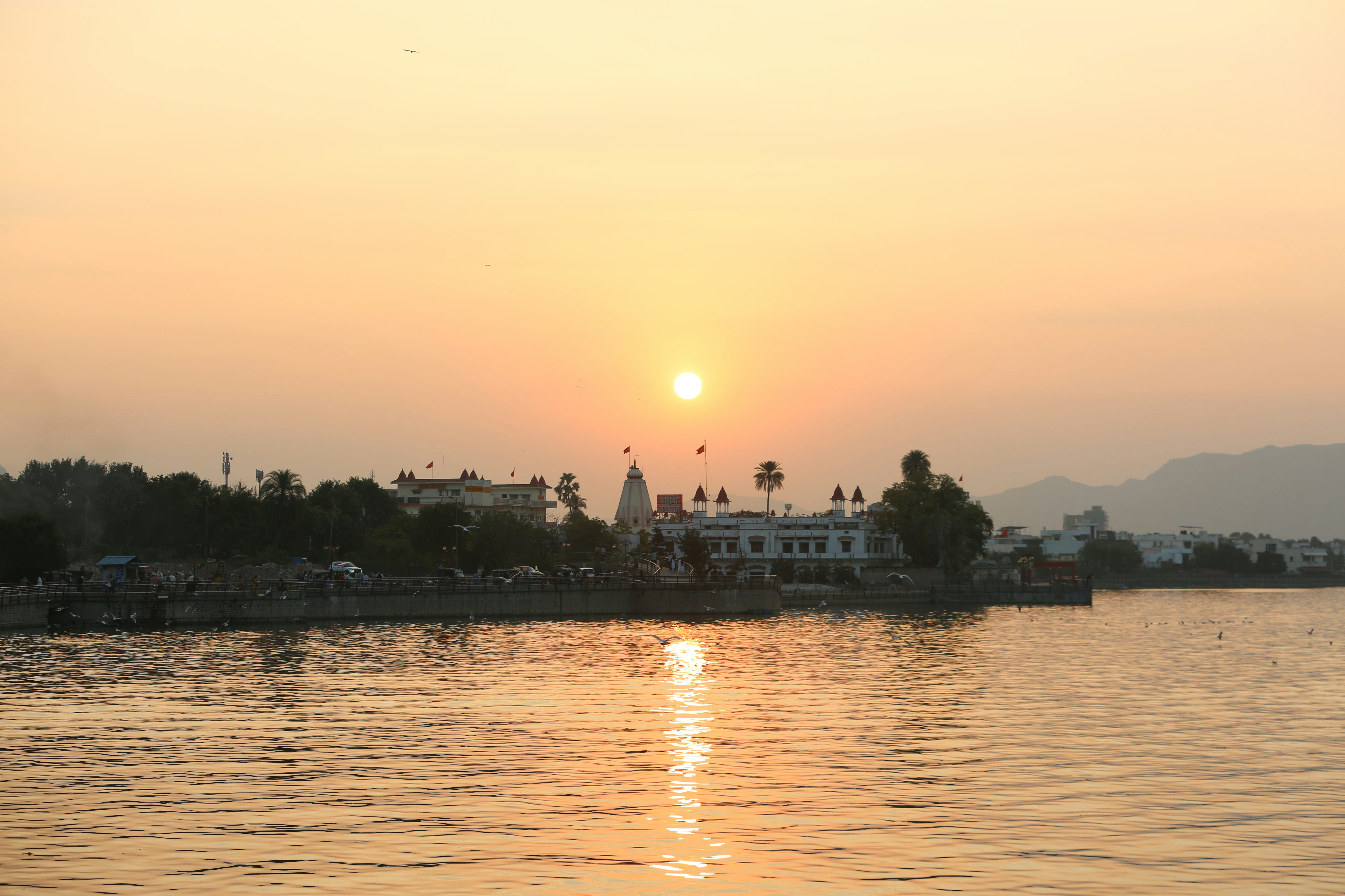 Golden temple at sunset with reflection in water