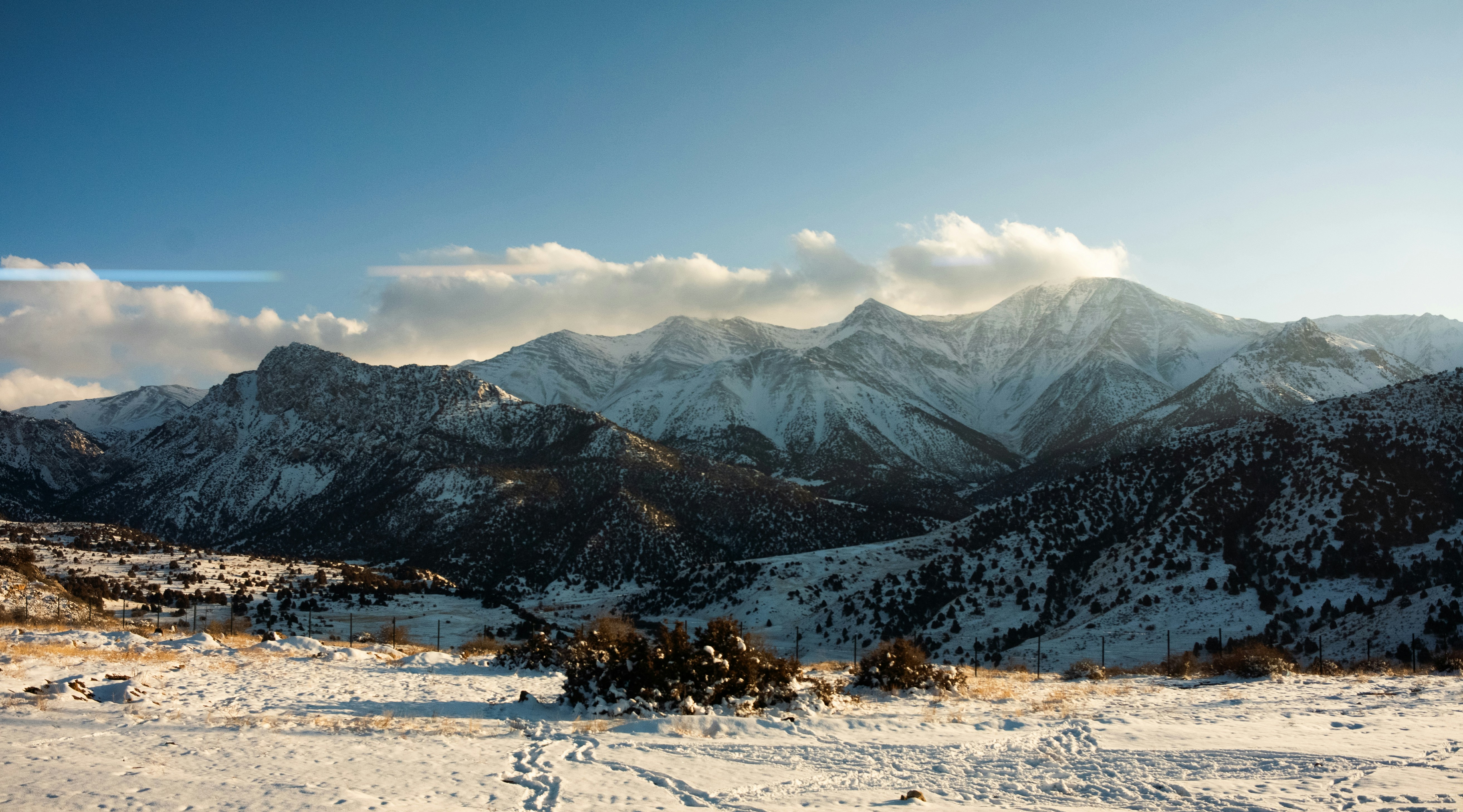 Snow-covered mountains under a bright blue sky
