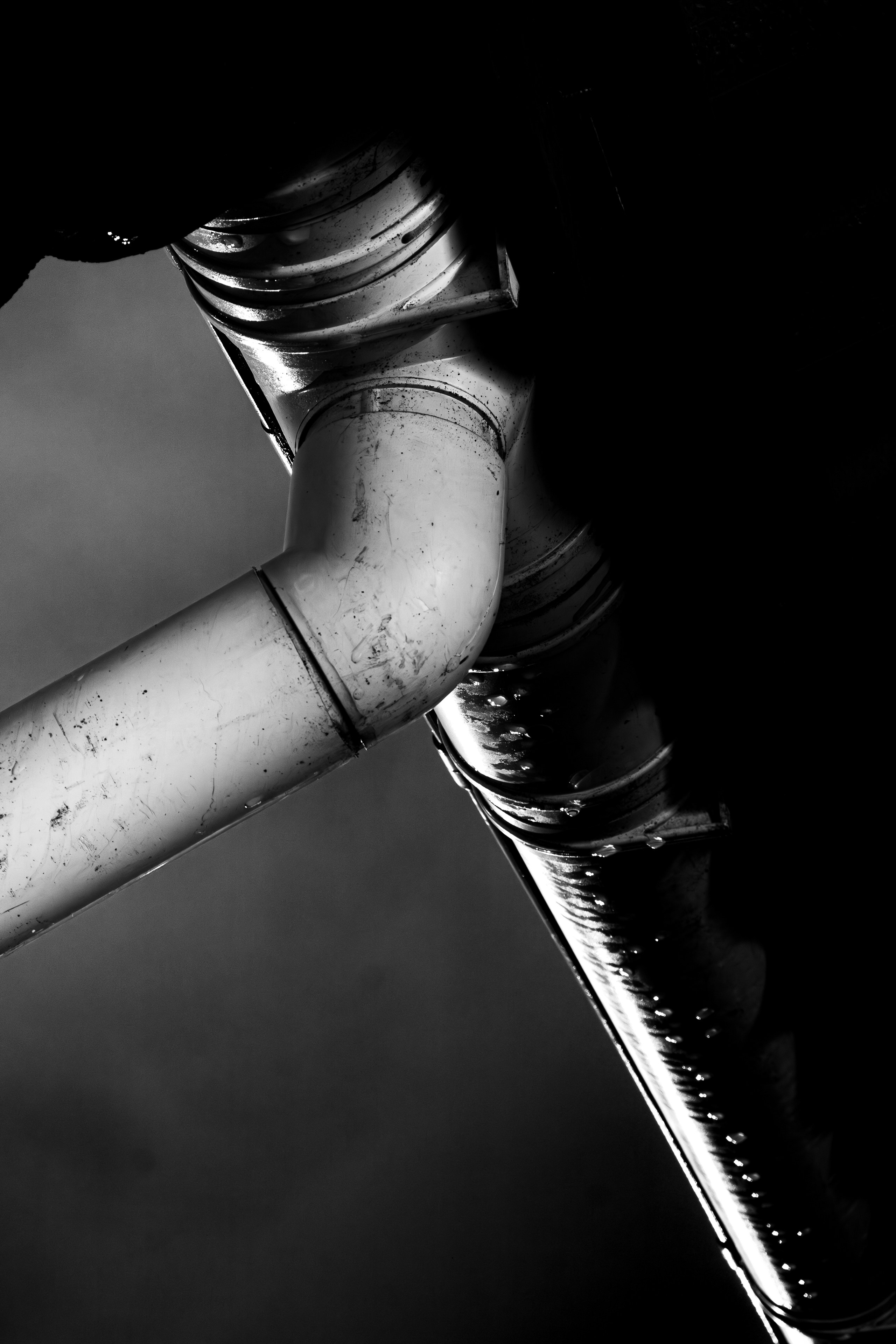 Plumbing pipes beneath suburban home affected by moisture and usage