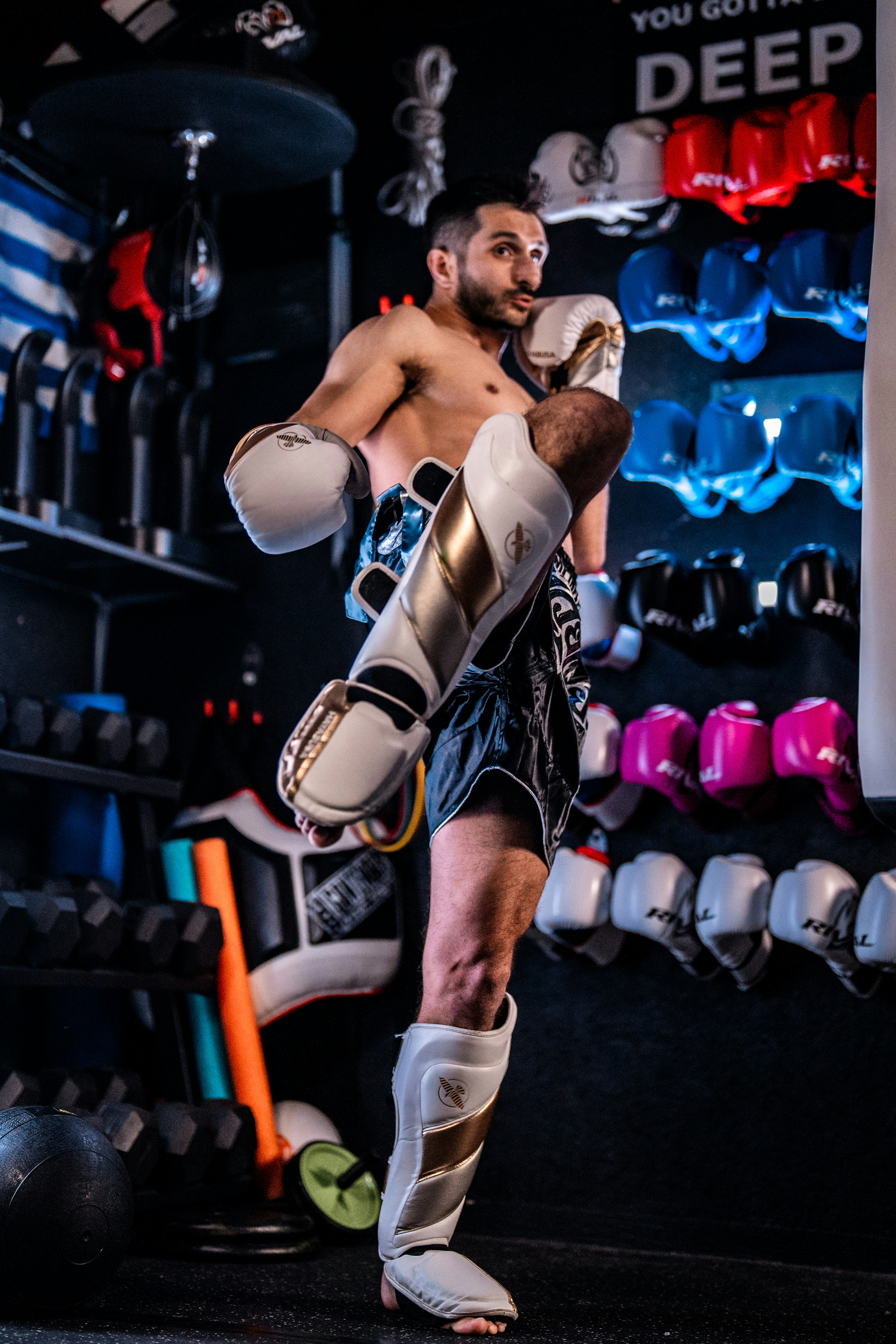 Man practicing muay thai kickboxing in gym