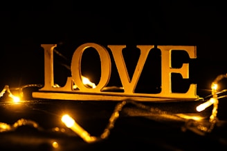 Golden love sign with bokeh lights