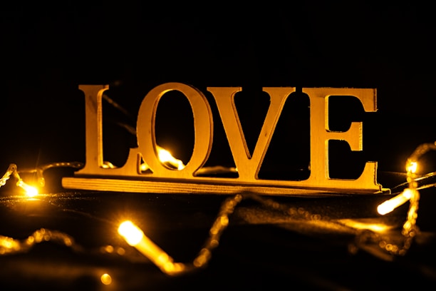 Golden love sign with bokeh lights