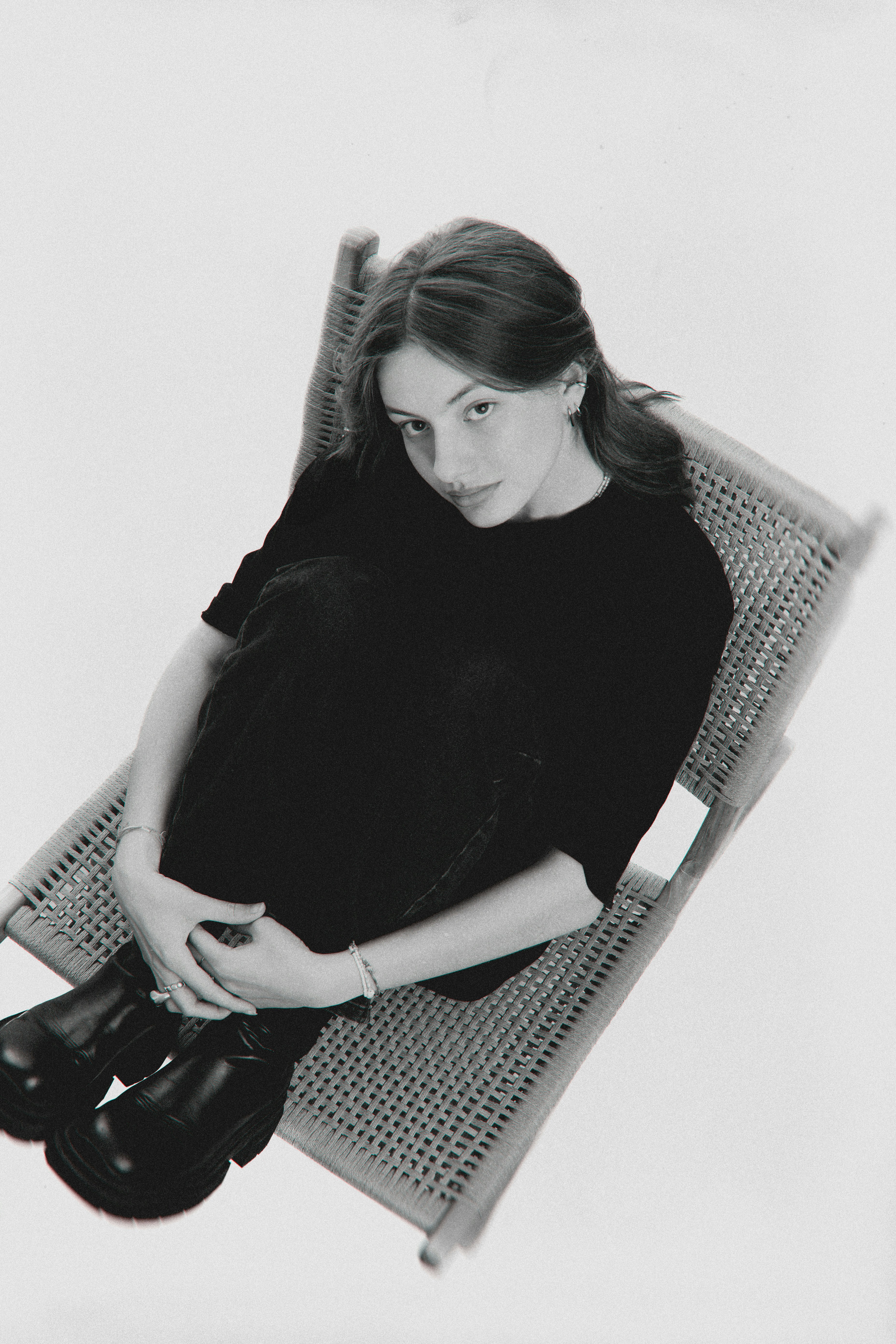 Young woman in black sitting on a chair
