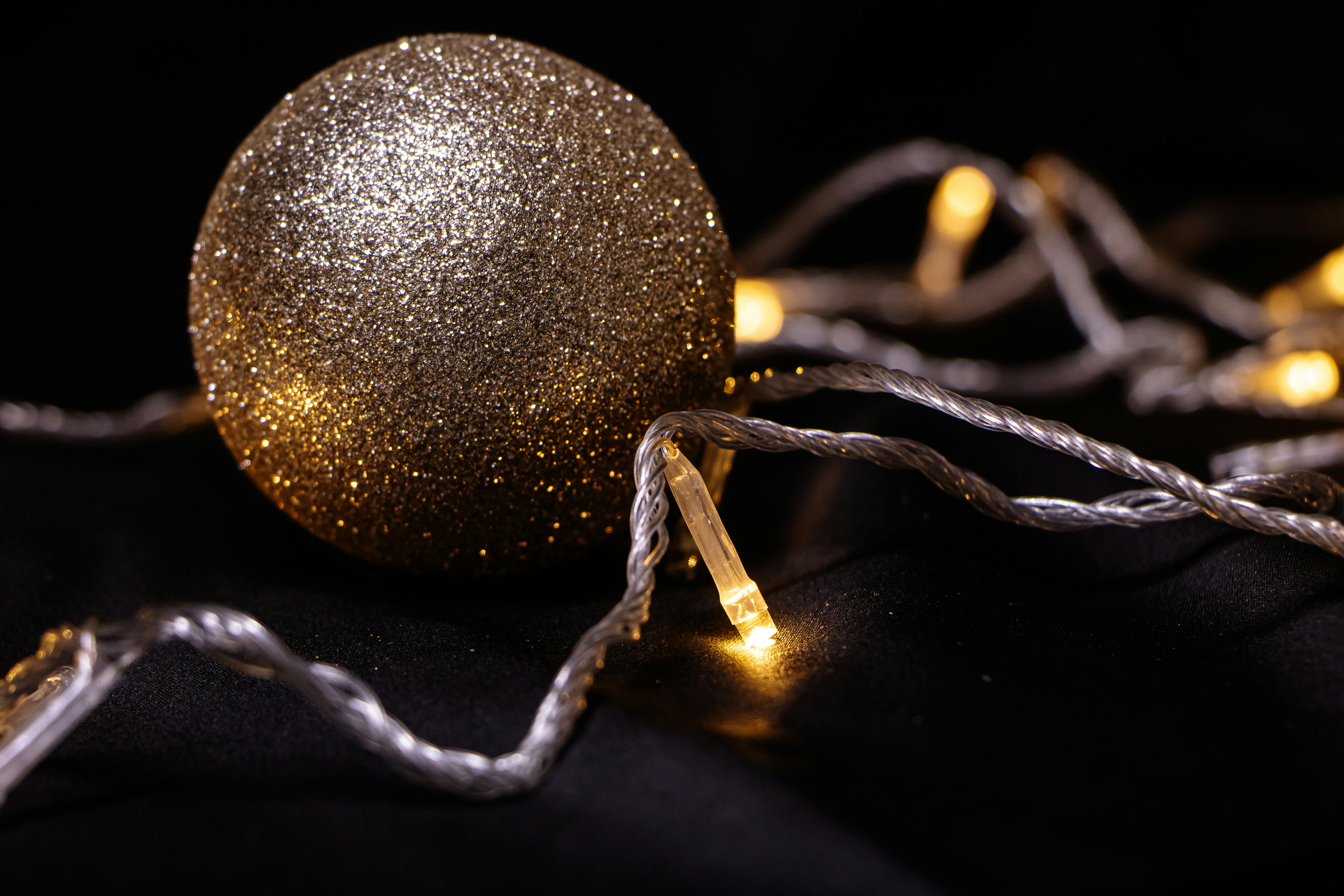 Golden glitter ornament with warm string lights