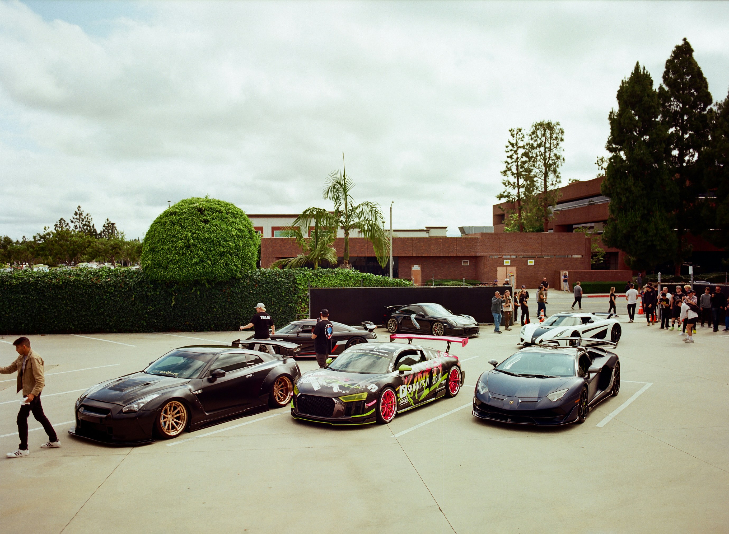 Several luxury sports cars parked outside a building.