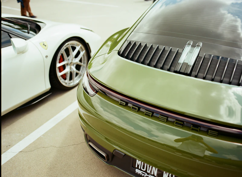 Two opulent luxury sports cars, green and white.