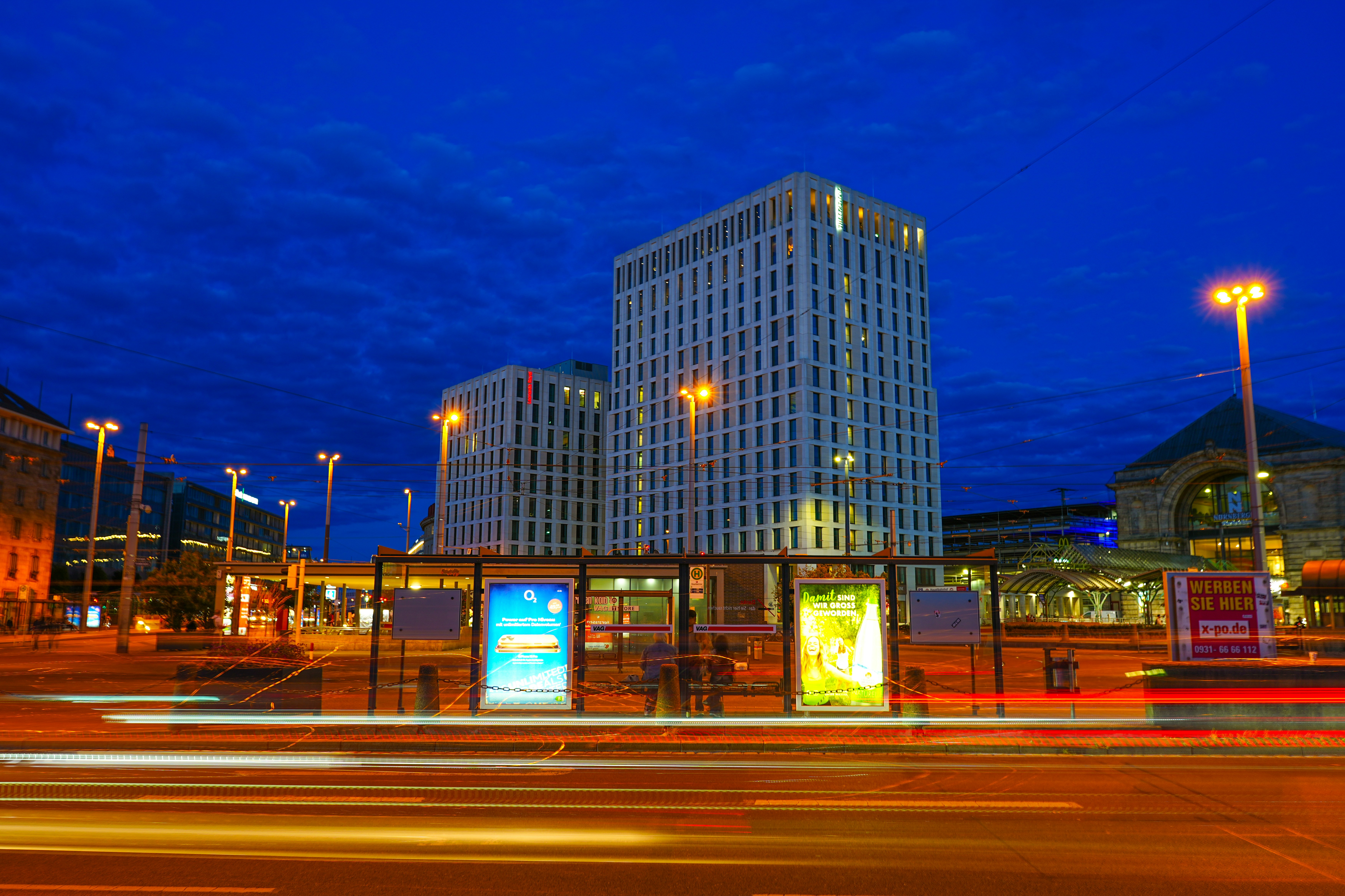 City buildings at night with light trails