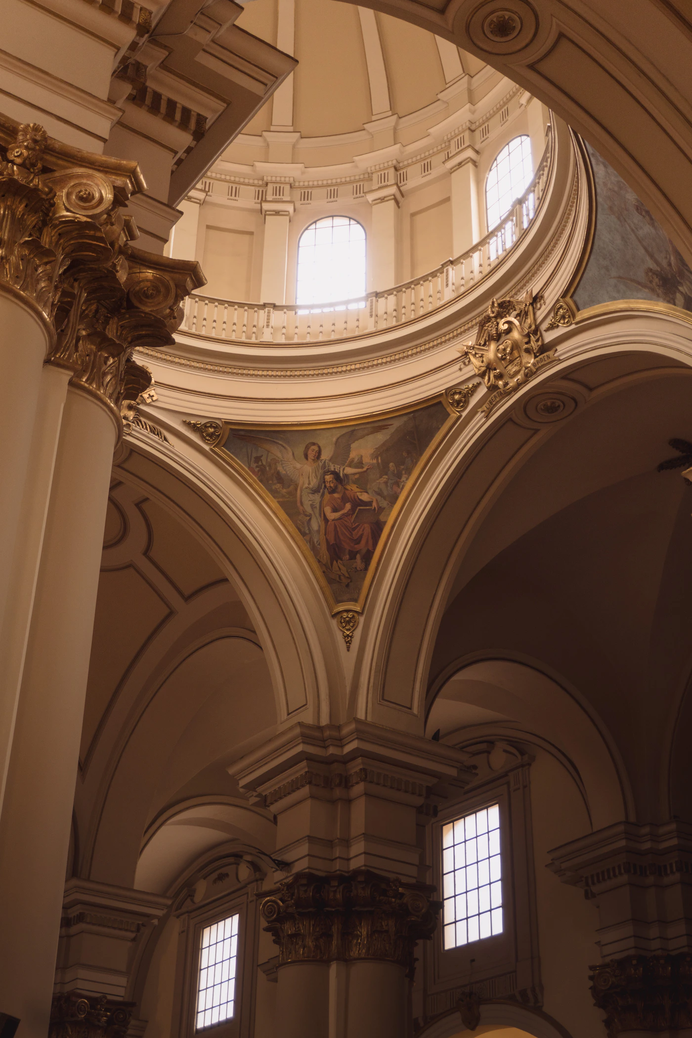 Grand Colombian cathedral interior with ornate dome, chandeliers and stained glass