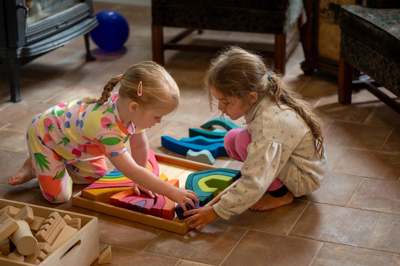 Two children using colorful wooden learning blocks during hands-on play