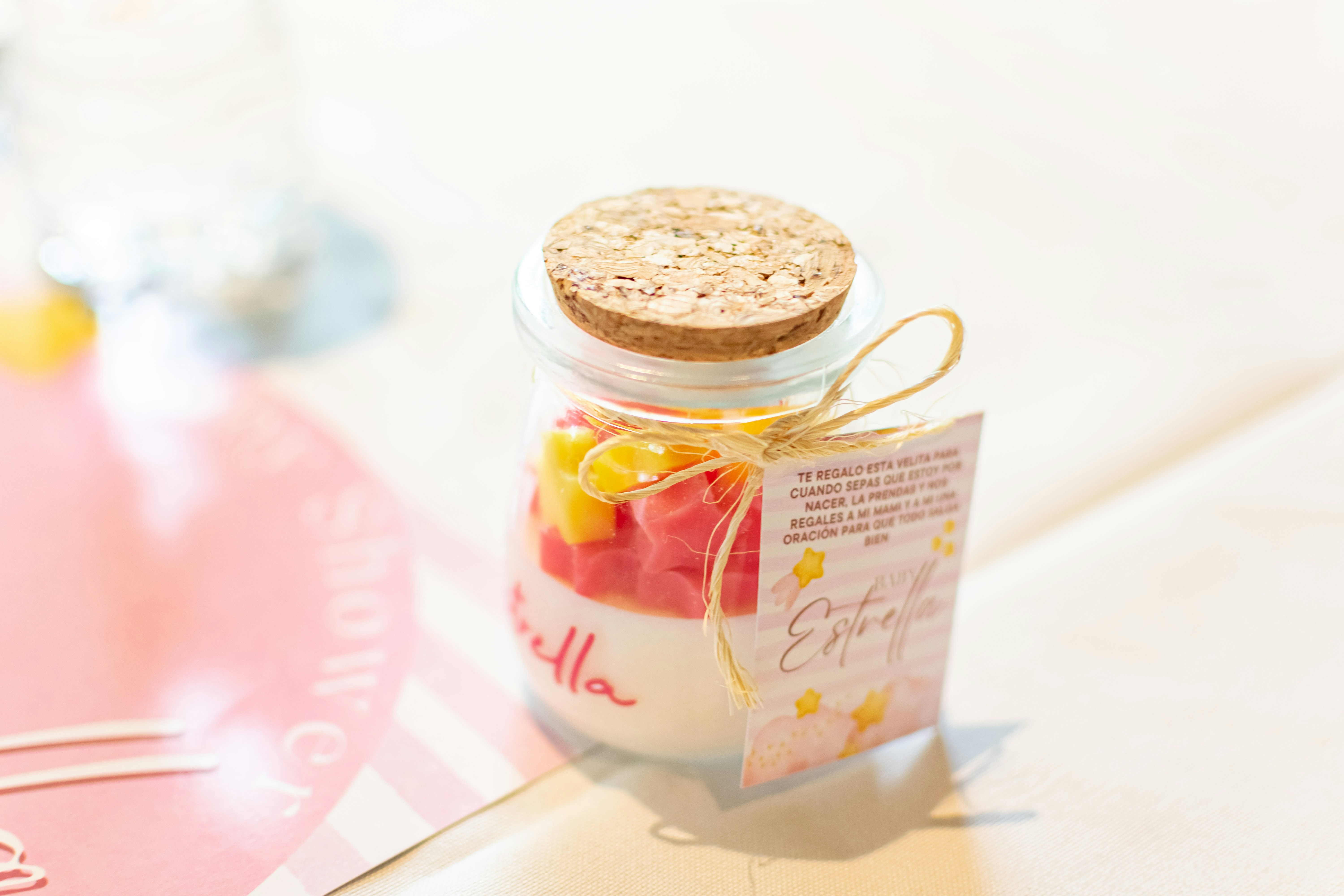 Small glass bottle with colorful candies and tag