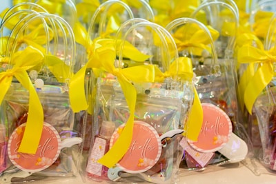 Clear gift bags with yellow ribbons and pink tags
