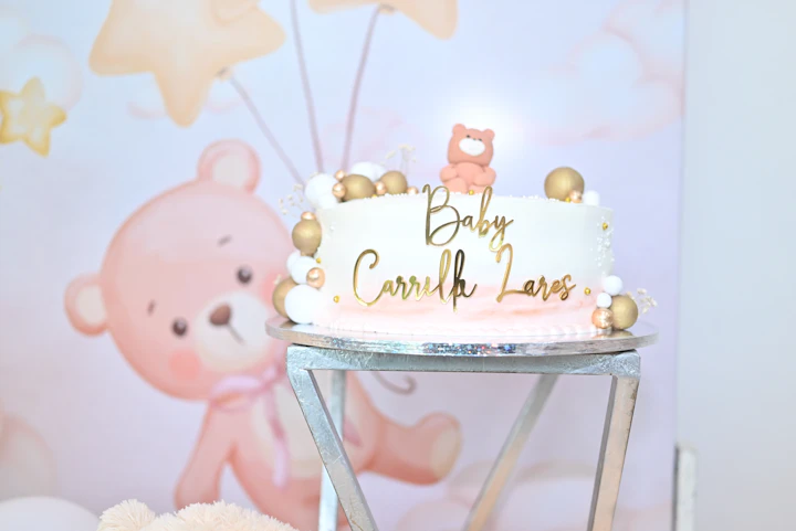 Baby shower cake with gold accents and teddy bear decorations