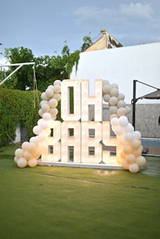 Illuminated "oh baby" sign with balloons