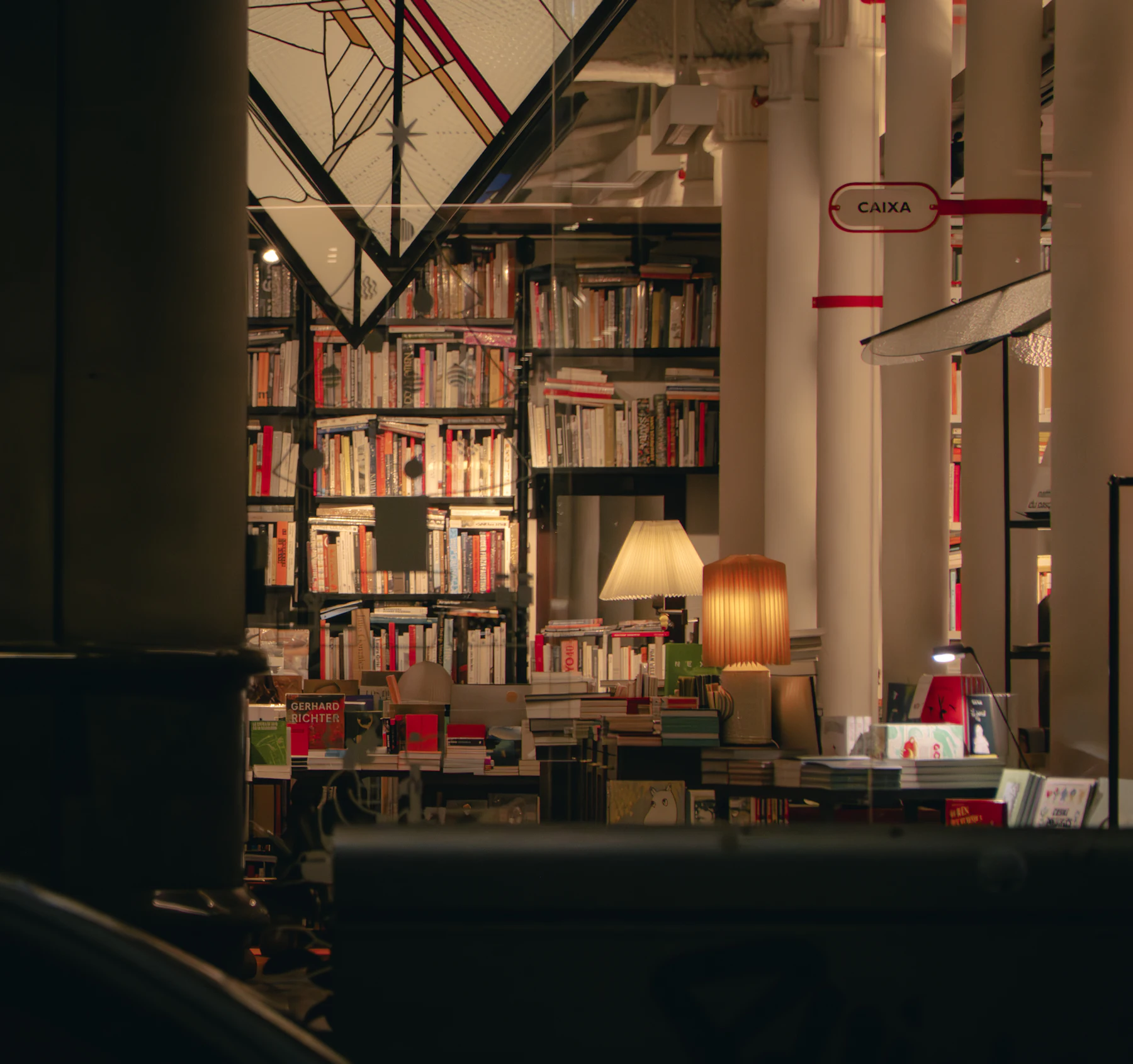 A warmly lit bookshop interior with shelves