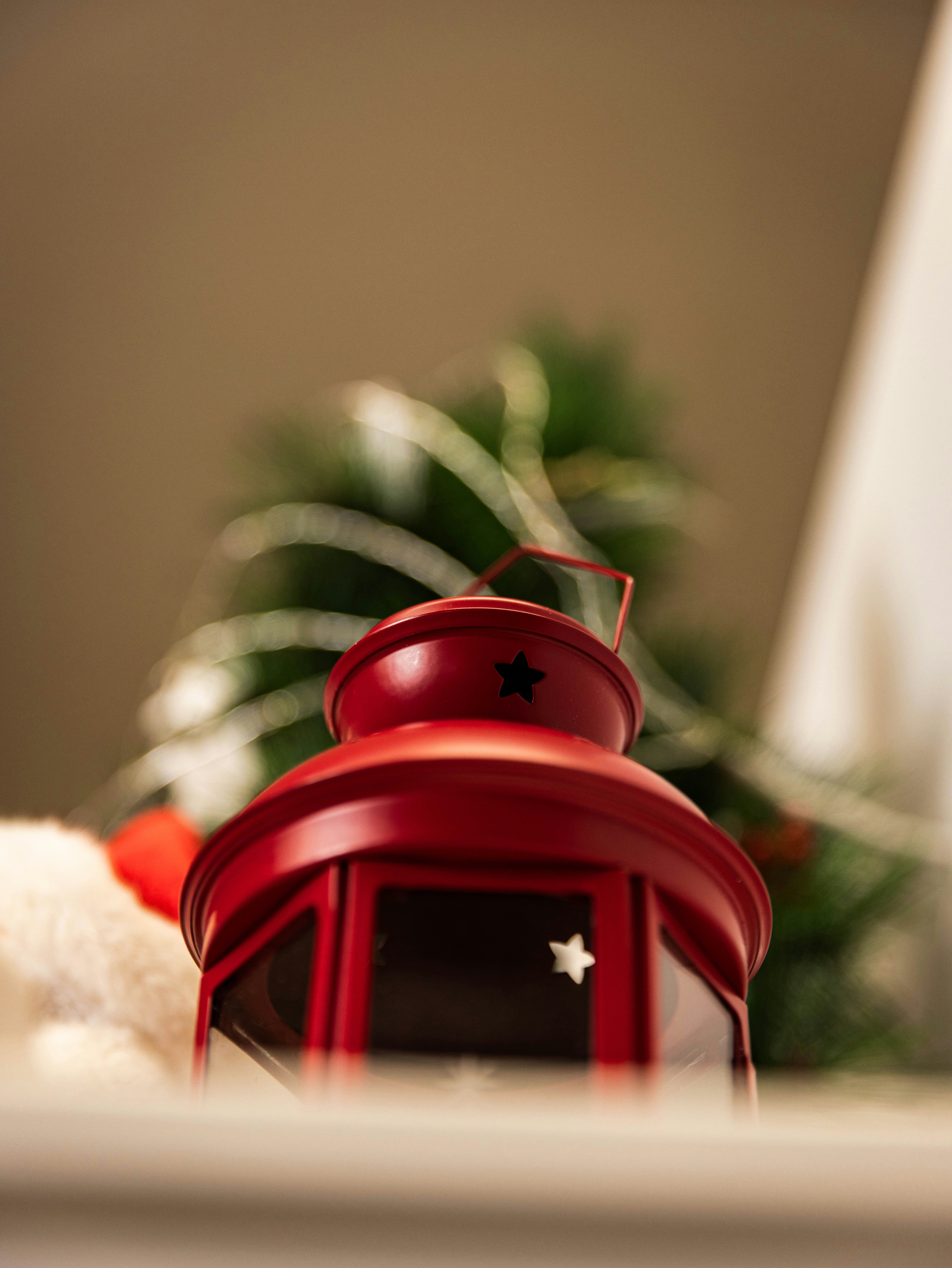 Red lantern with christmas tree in background