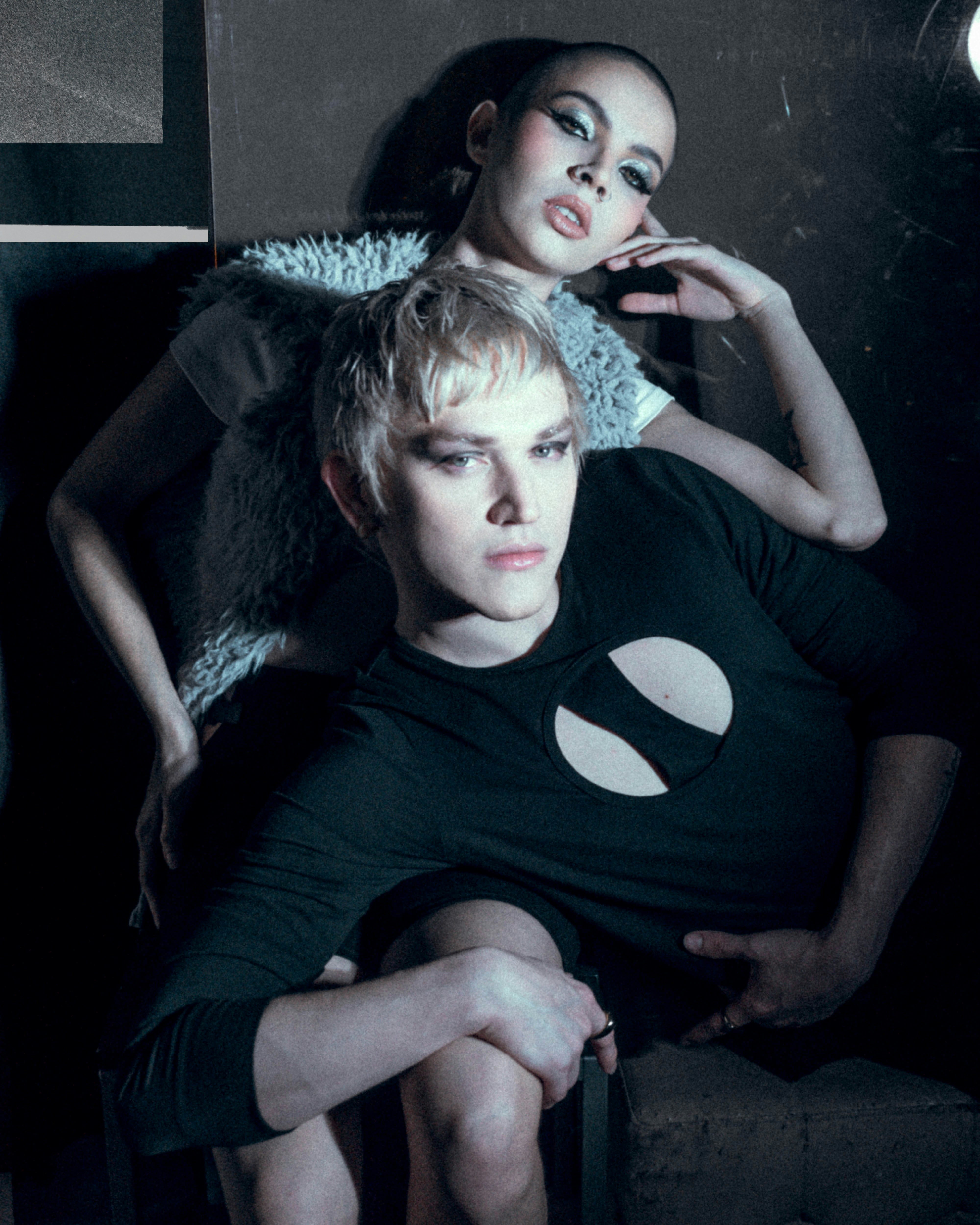 Two models posing with dramatic makeup and lighting