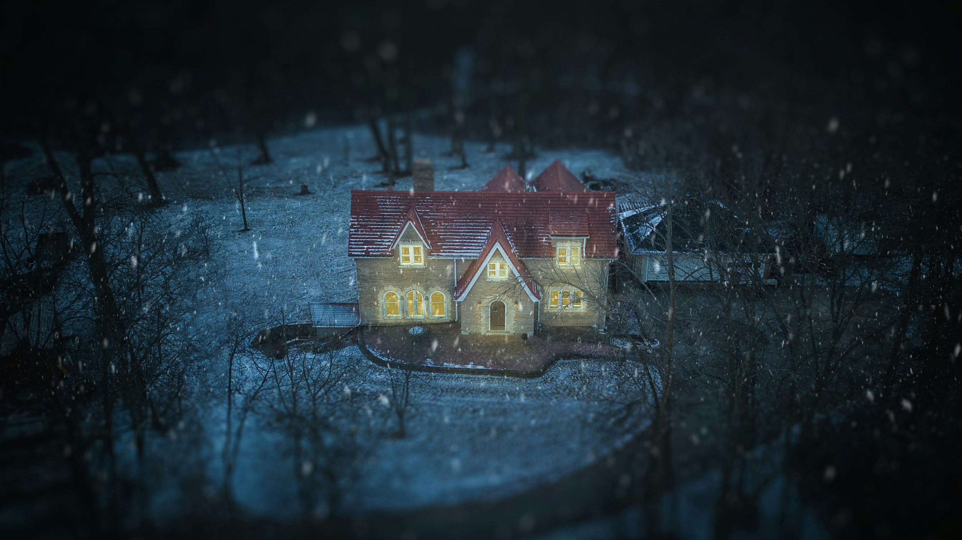 Cozy house with warm lights on a snowy night.