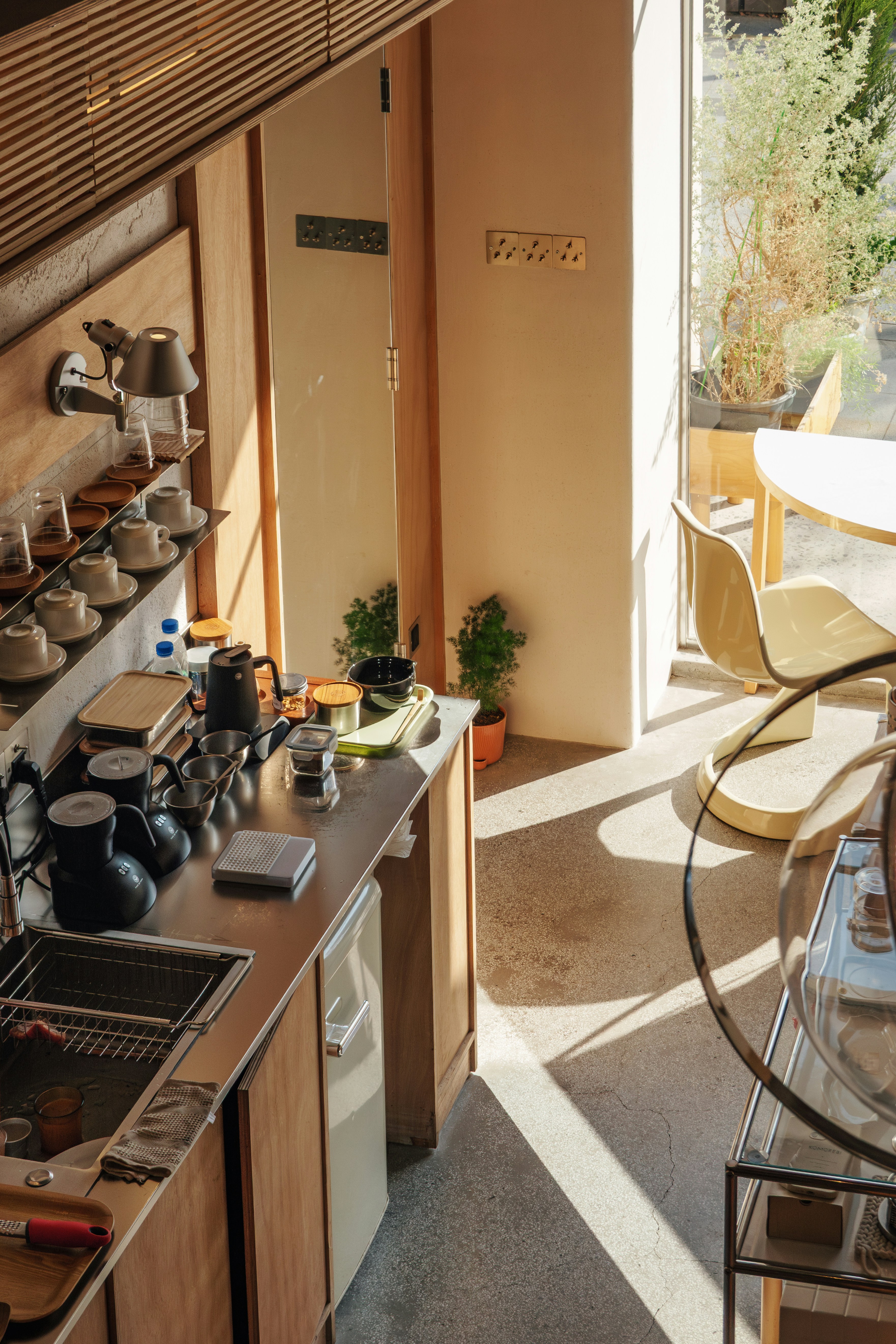Modern kitchen counter with coffee making supplies.