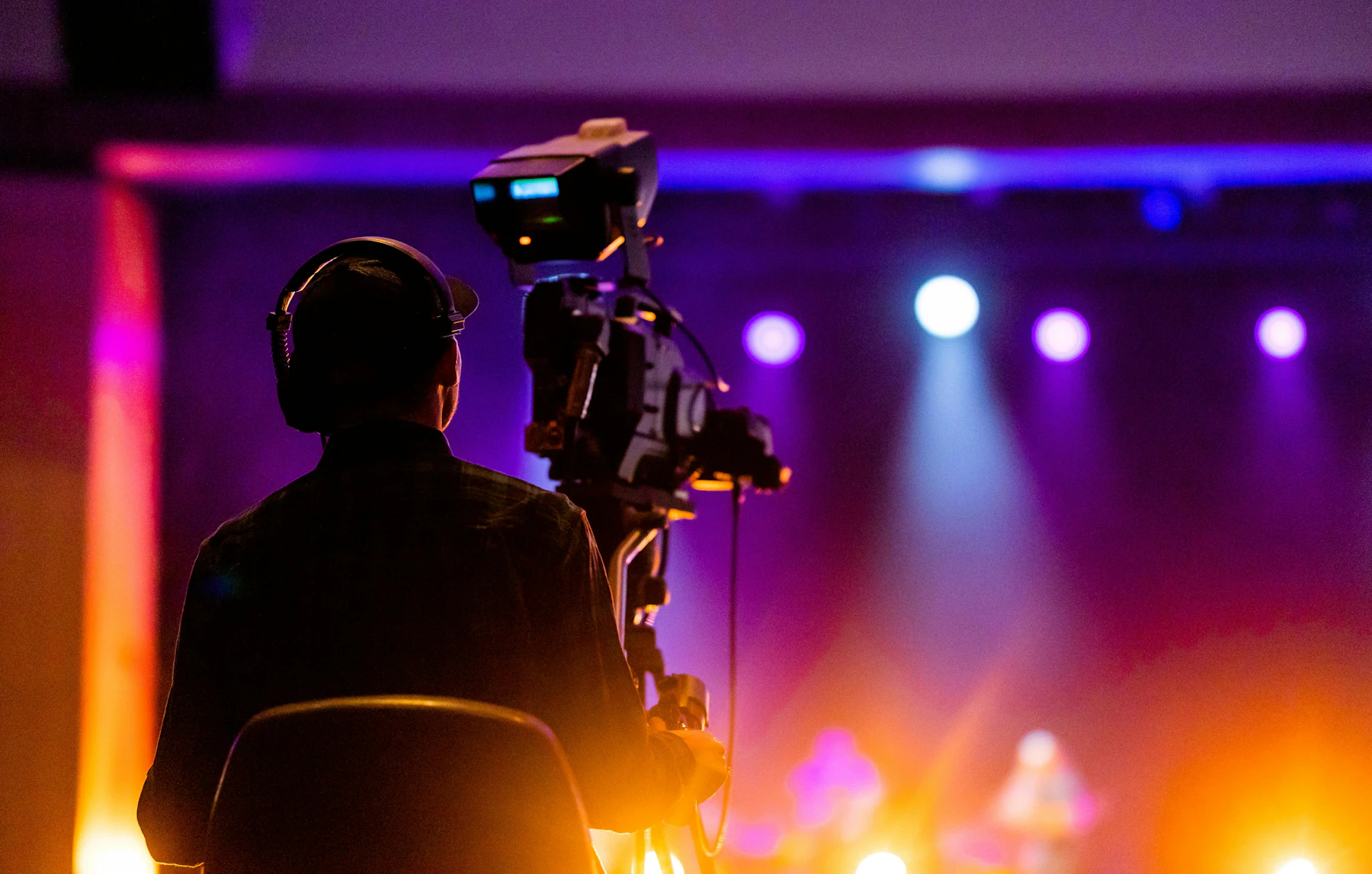 Camera operator filming a live event stage