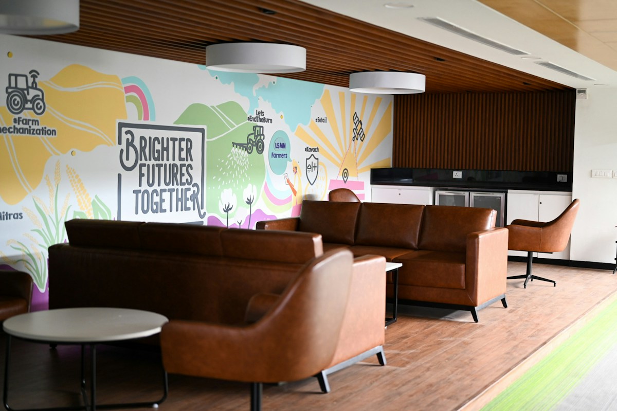 Modern lounge area with colorful mural and cozy seating, ideal for hosting volunteer appreciation events.