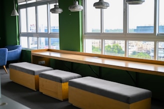 Modern seating area with large windows and city view.