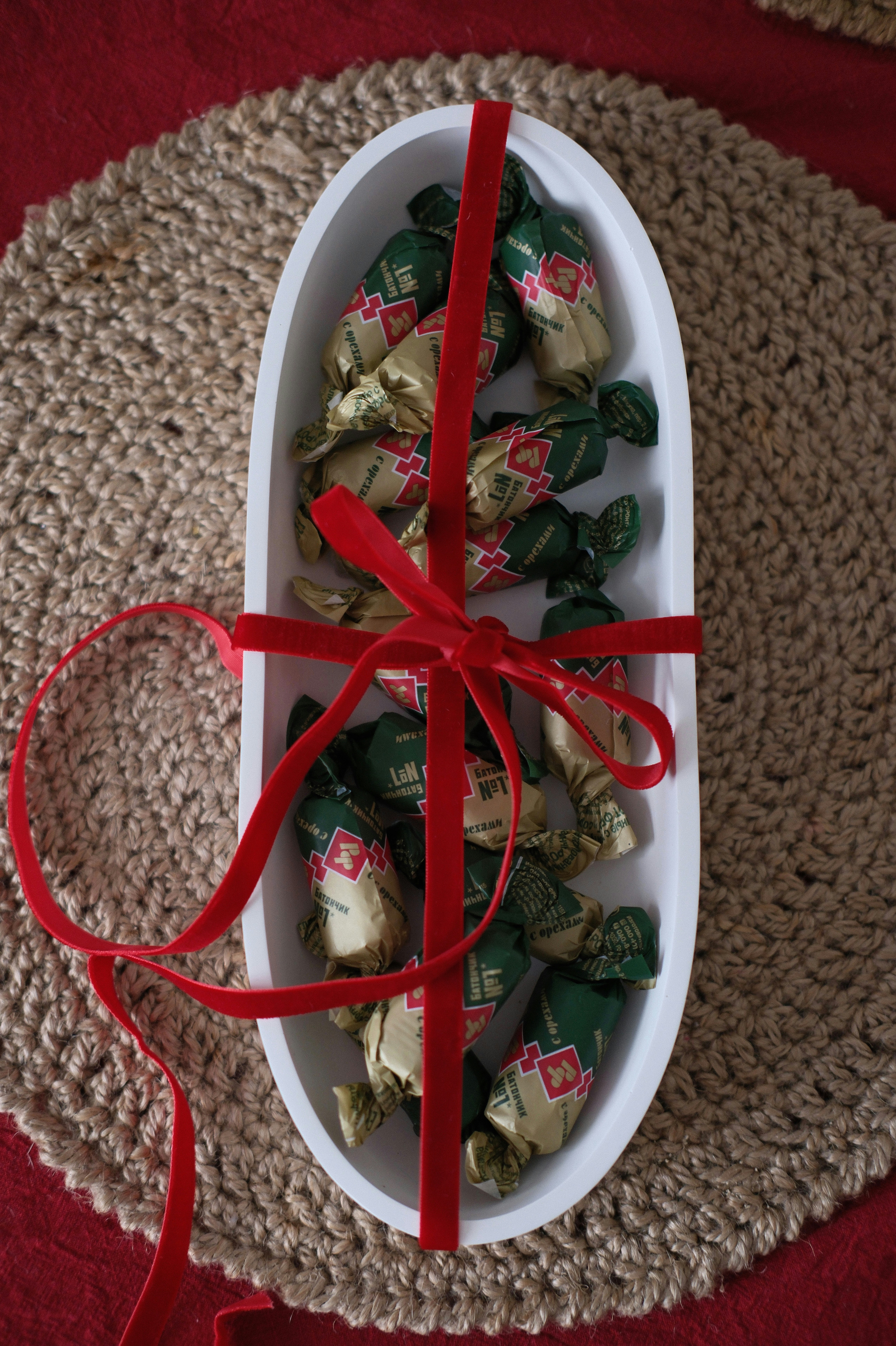 Chocolates wrapped in gold and green foil tied with ribbon
