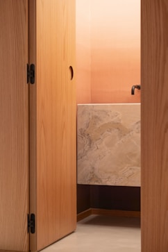 Modern bathroom with marble vanity and ombre wall.