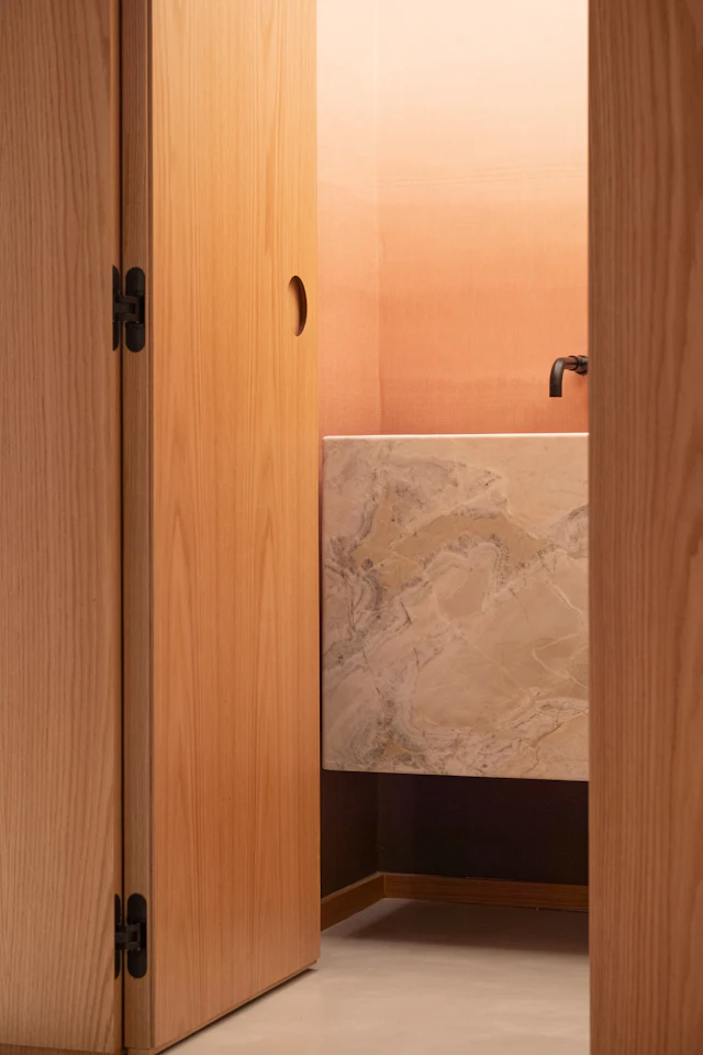 Modern bathroom with marble vanity and ombre wall