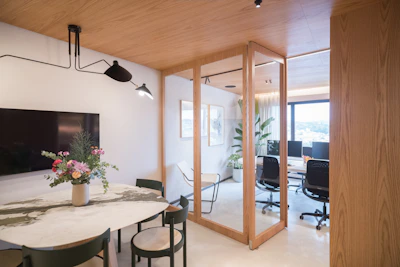 Modern office interior with meeting area and workstations.