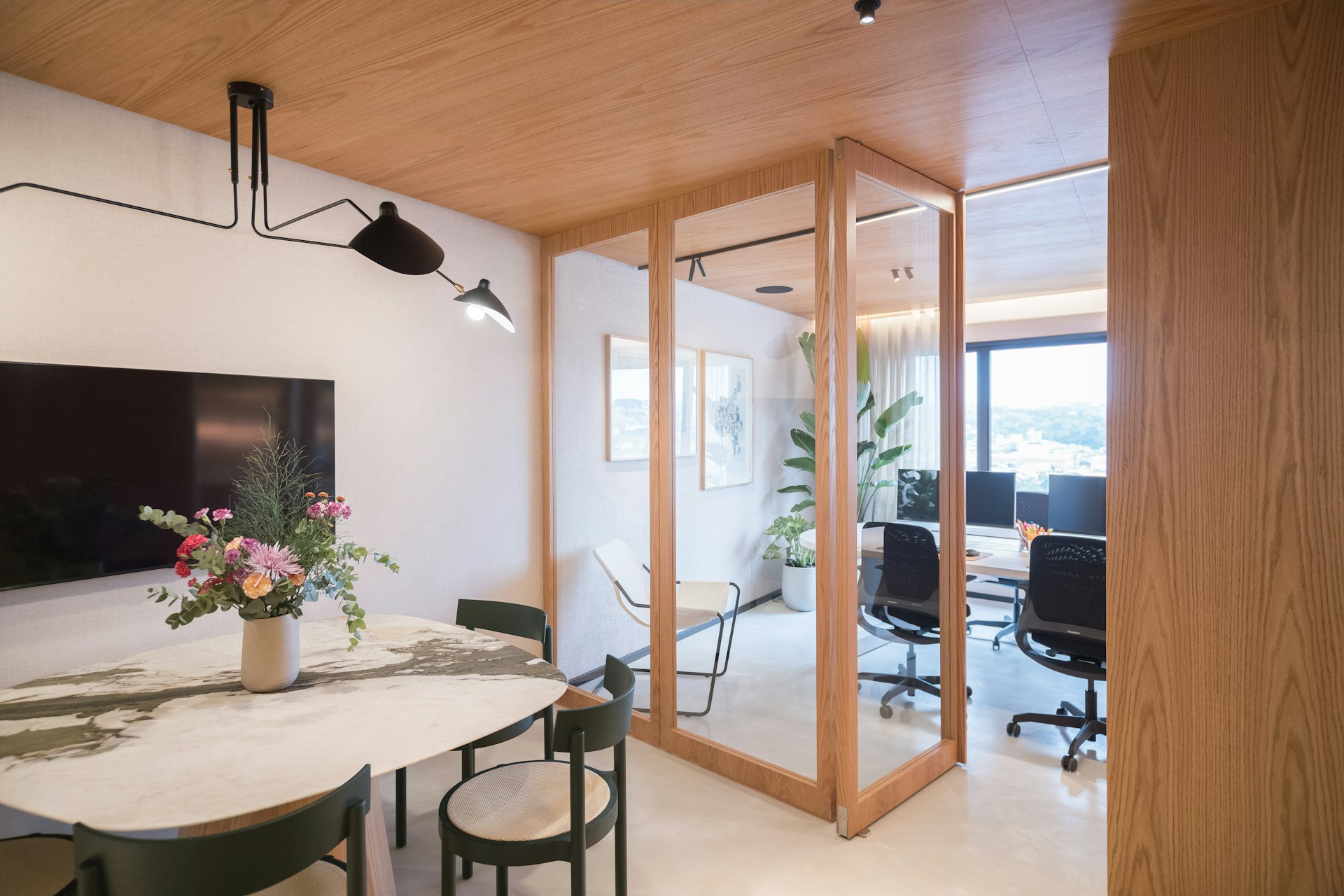 Modern office interior with meeting area and workstations.