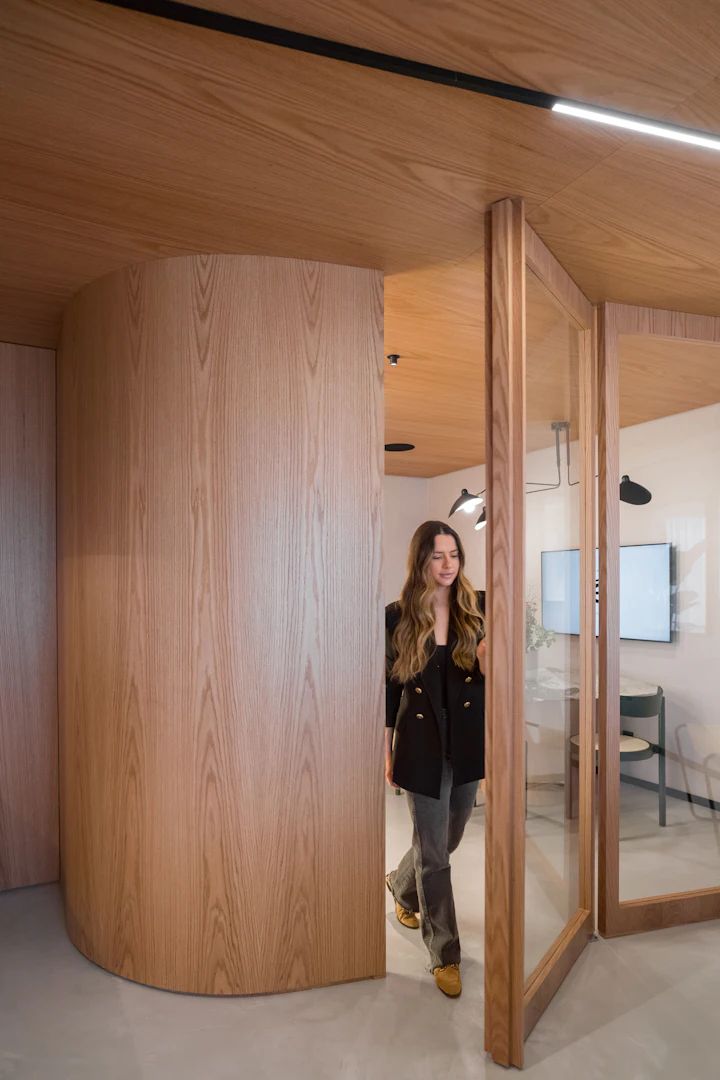 Woman walking through a modern office doorway