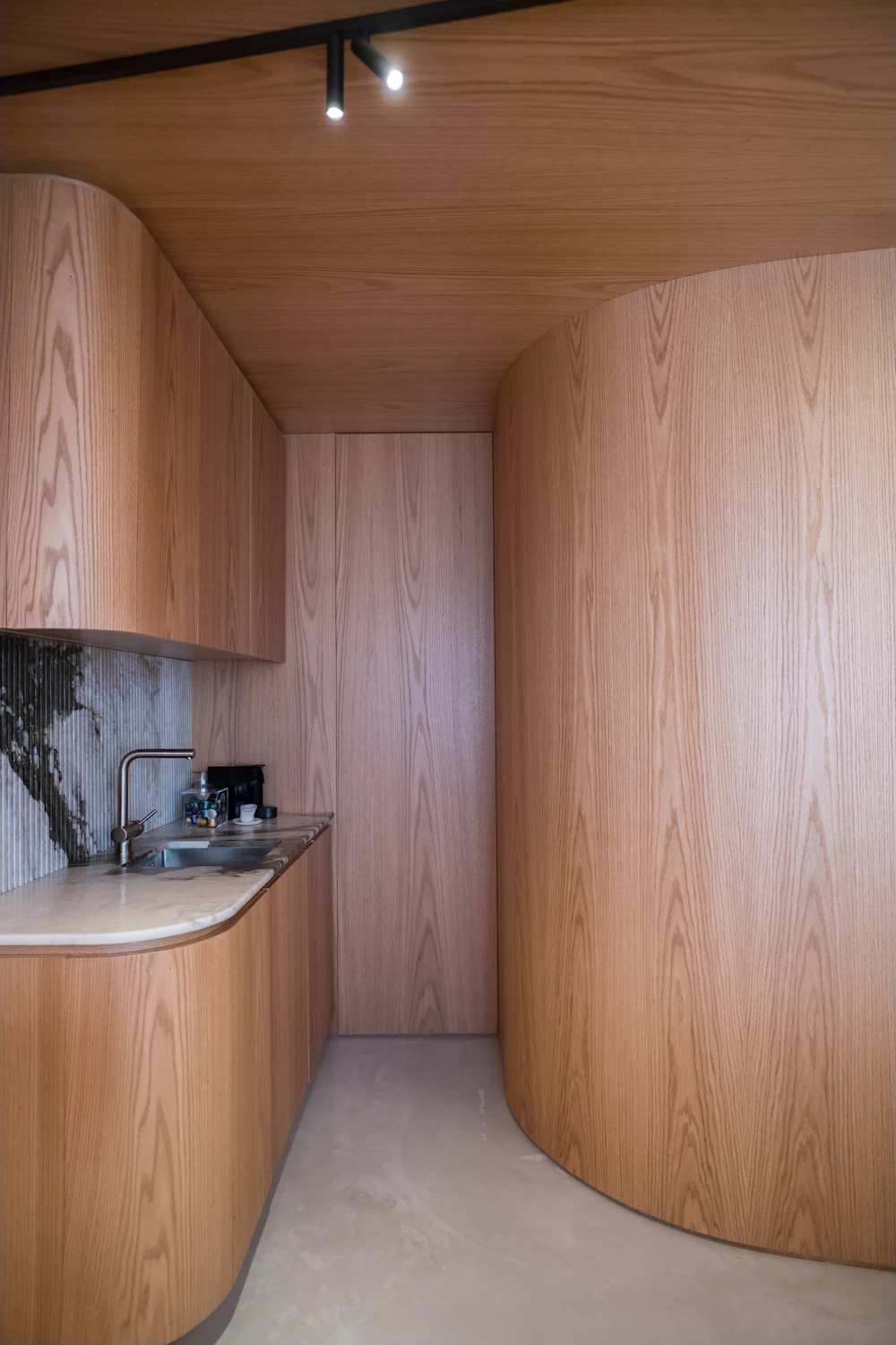 Fort Greene Loft — curved pale oak kitchen joinery
