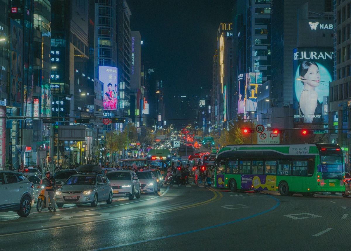 Busy city street at night with traffic and neon lights in Seoul
