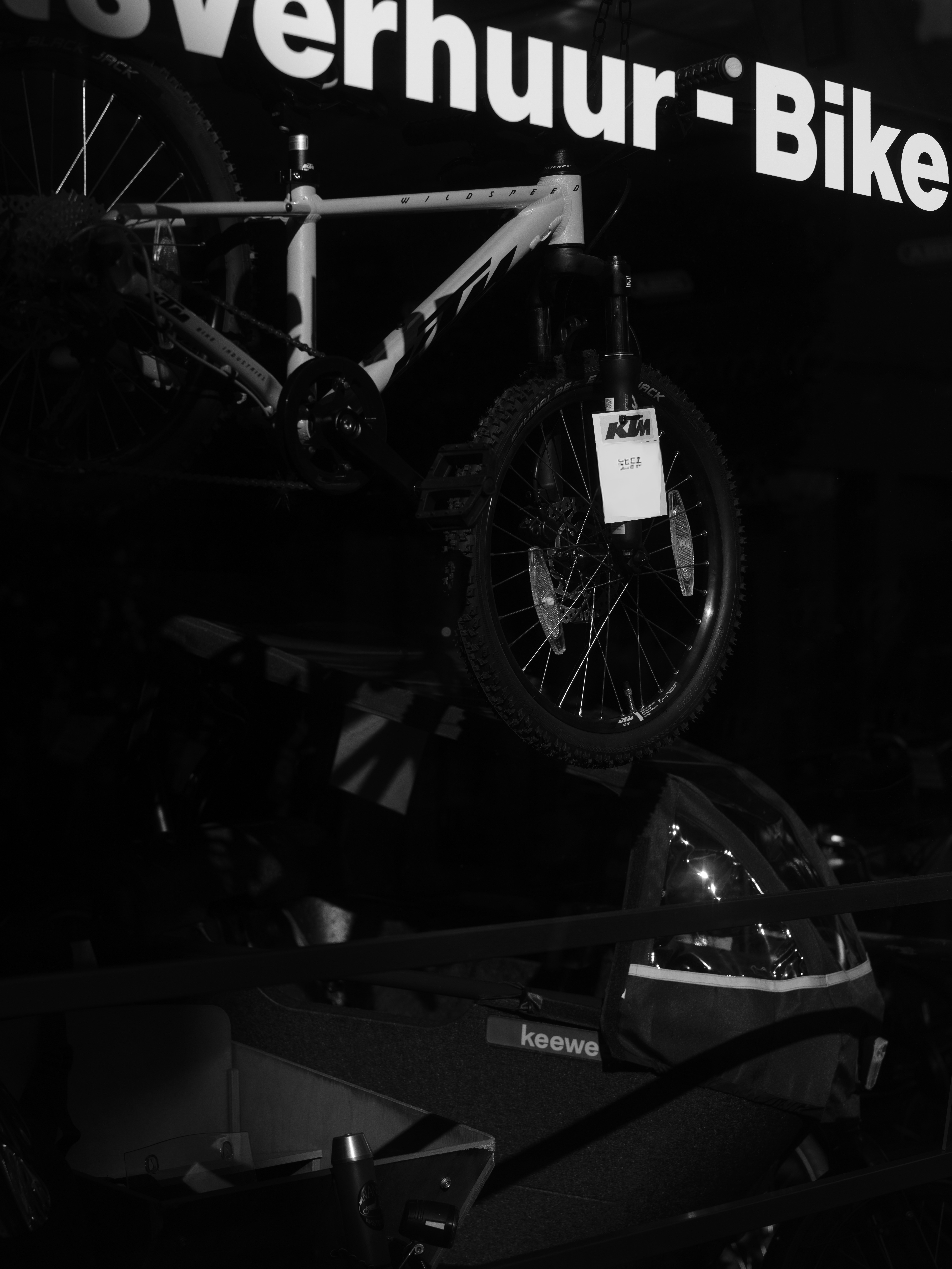 A bicycle with a tag hanging from handlebars.