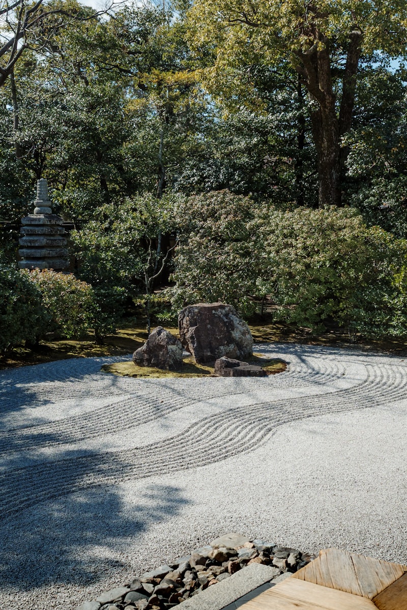 Raked gravel garden with rocks and trees