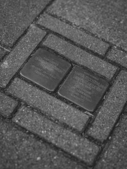 Two stolpersteine embedded in pavement