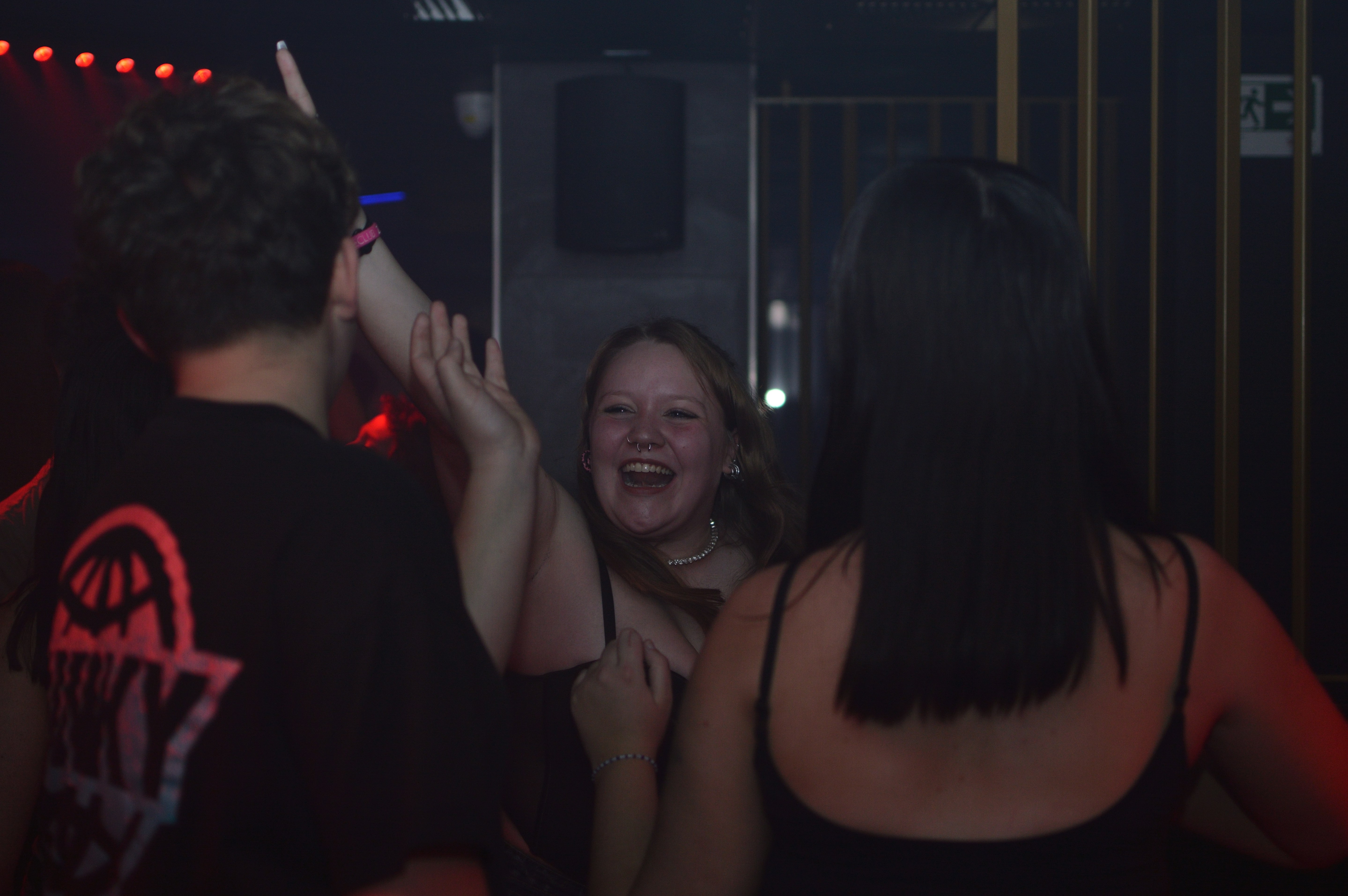Young people dancing and laughing at a club