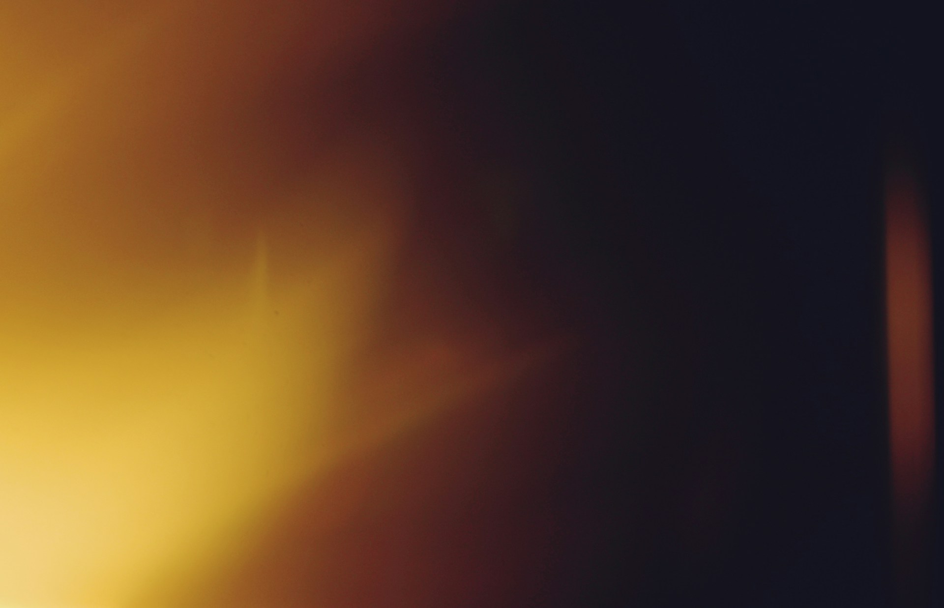 Abstract warm light flares on dark background