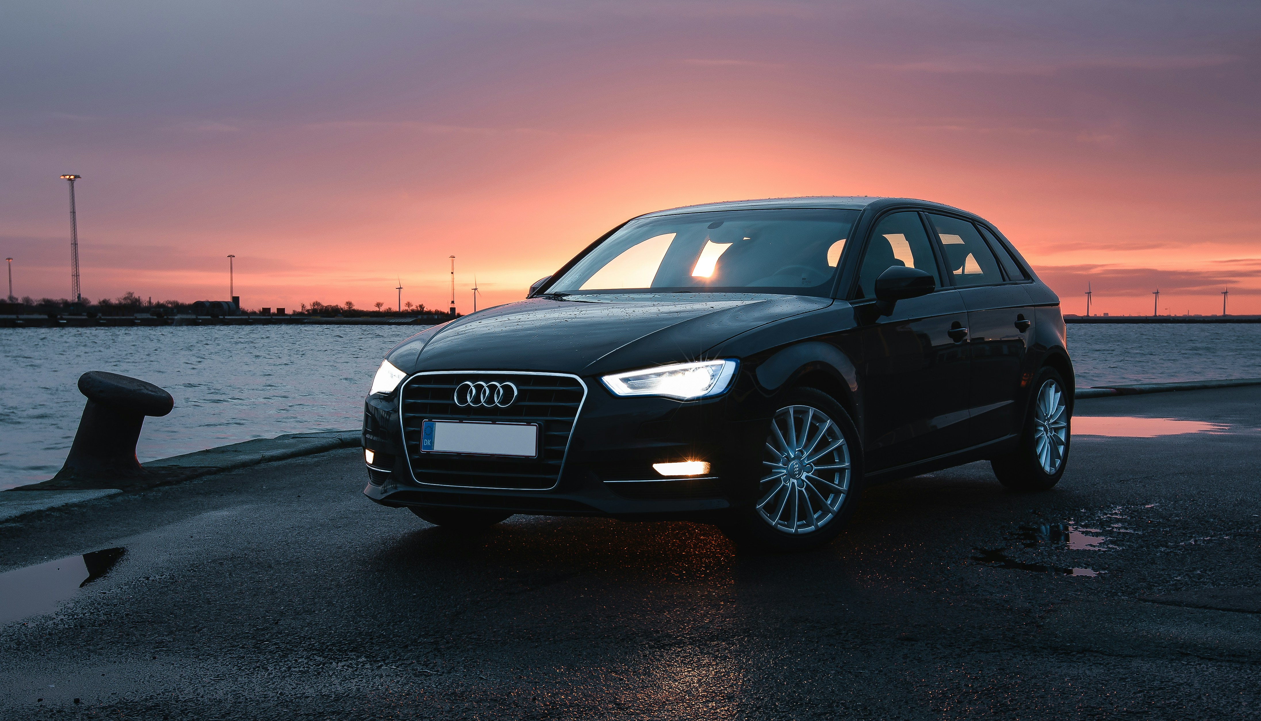 Black luxury car at pier