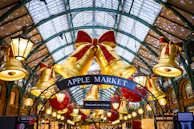 Golden bells and red bows decorate apple market