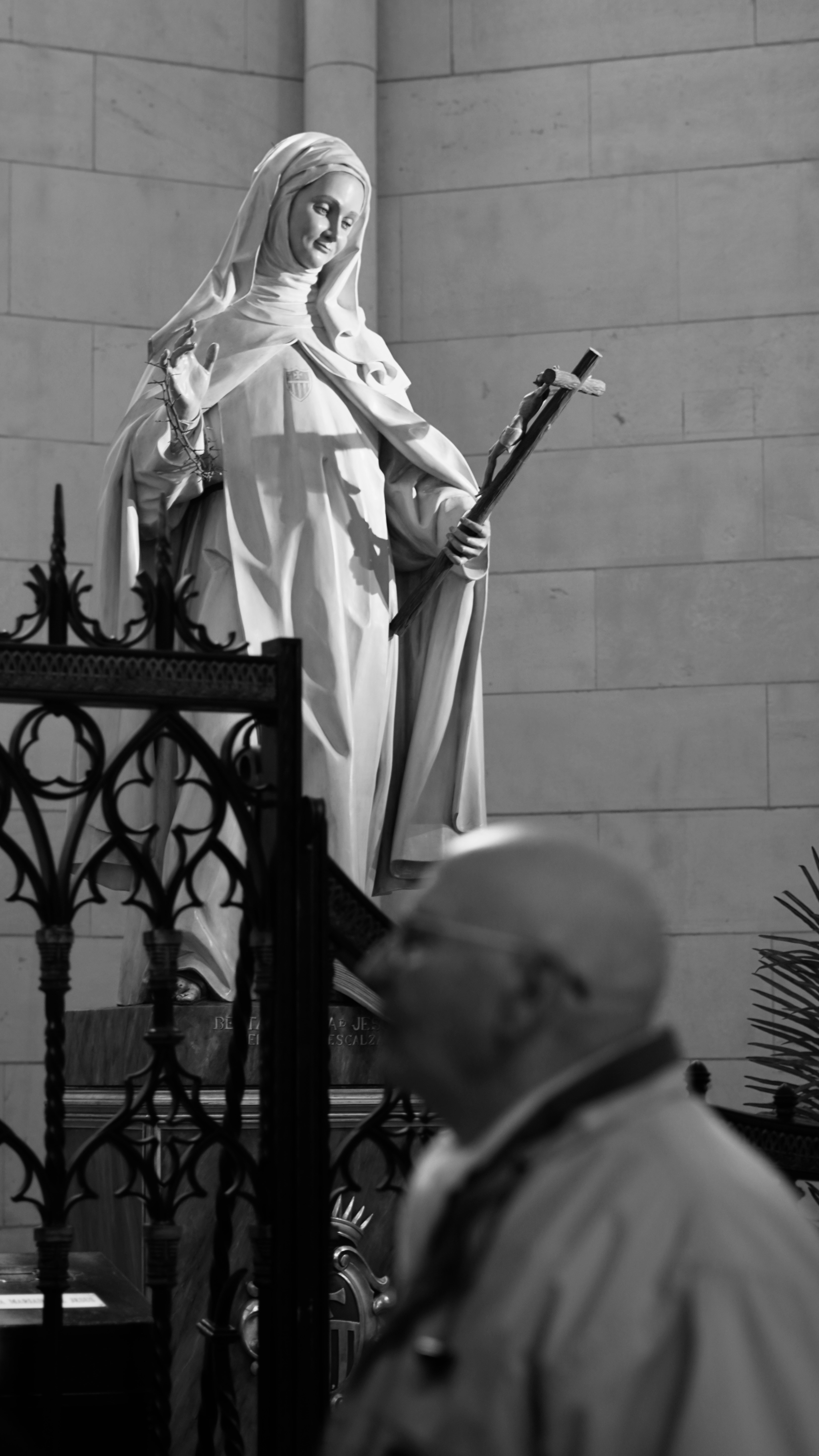 A statue of a woman holding a cross