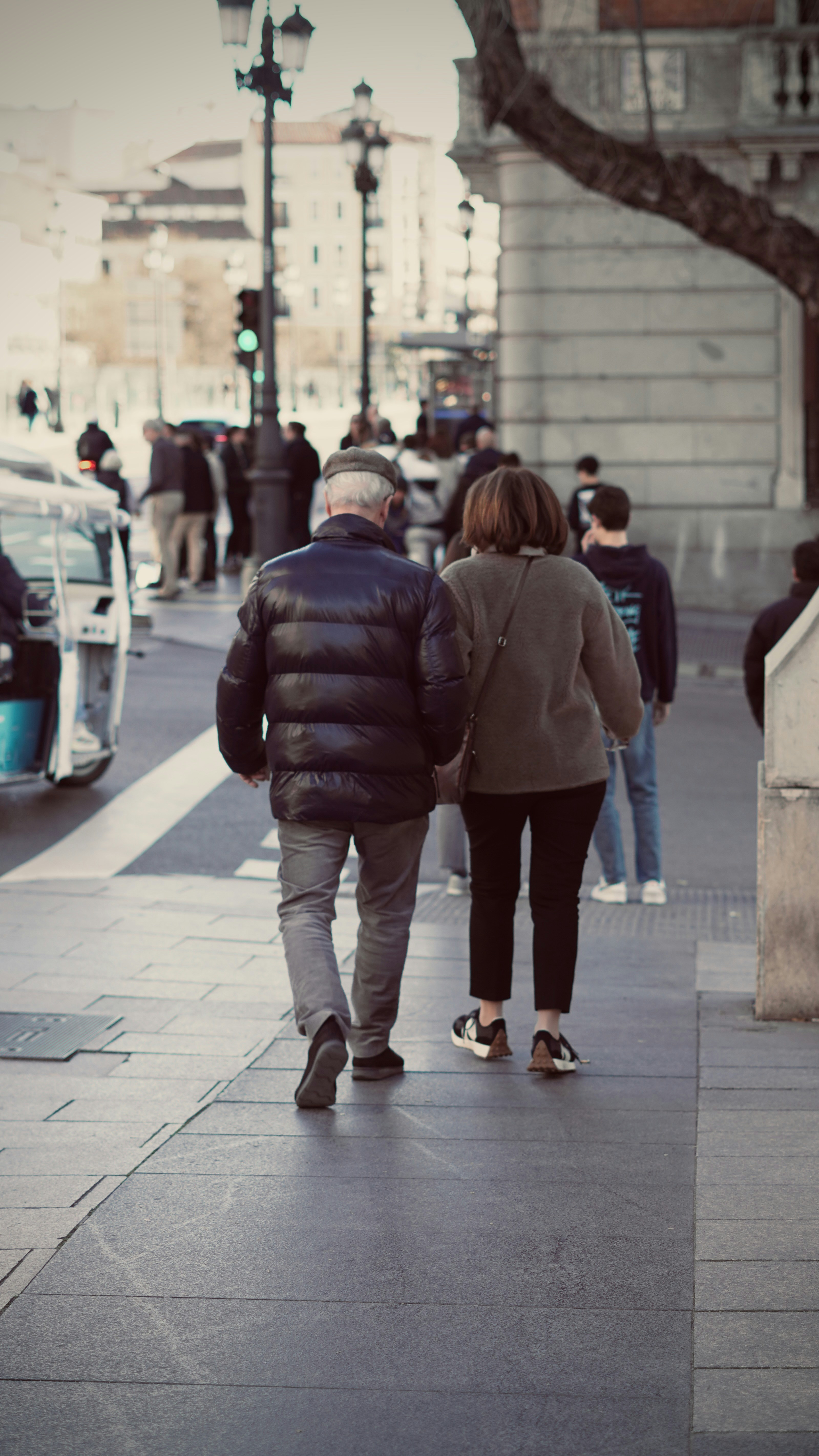 Elderly couple walking on a city sidewalk