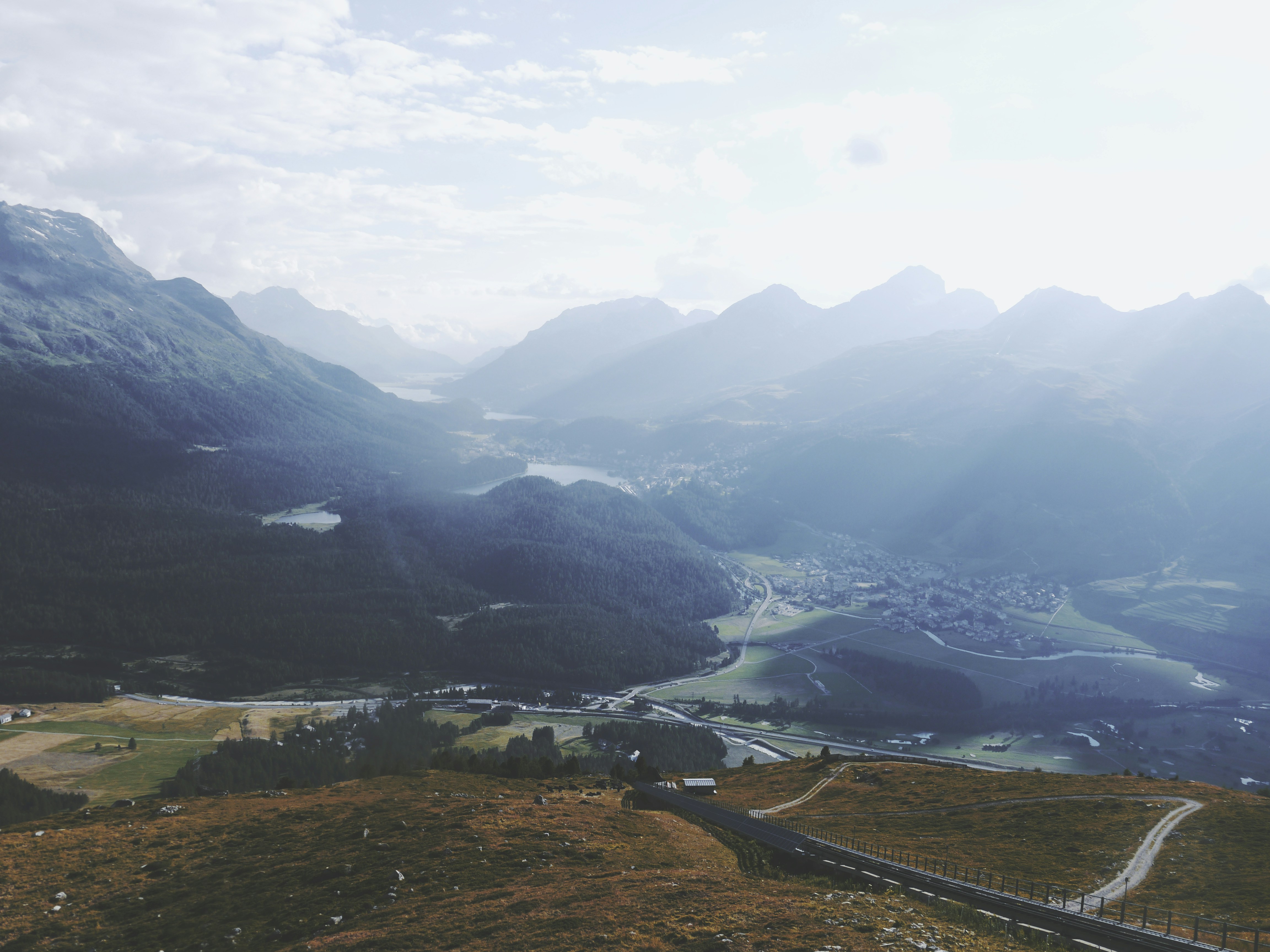 Misty mountains and valley with a road below road