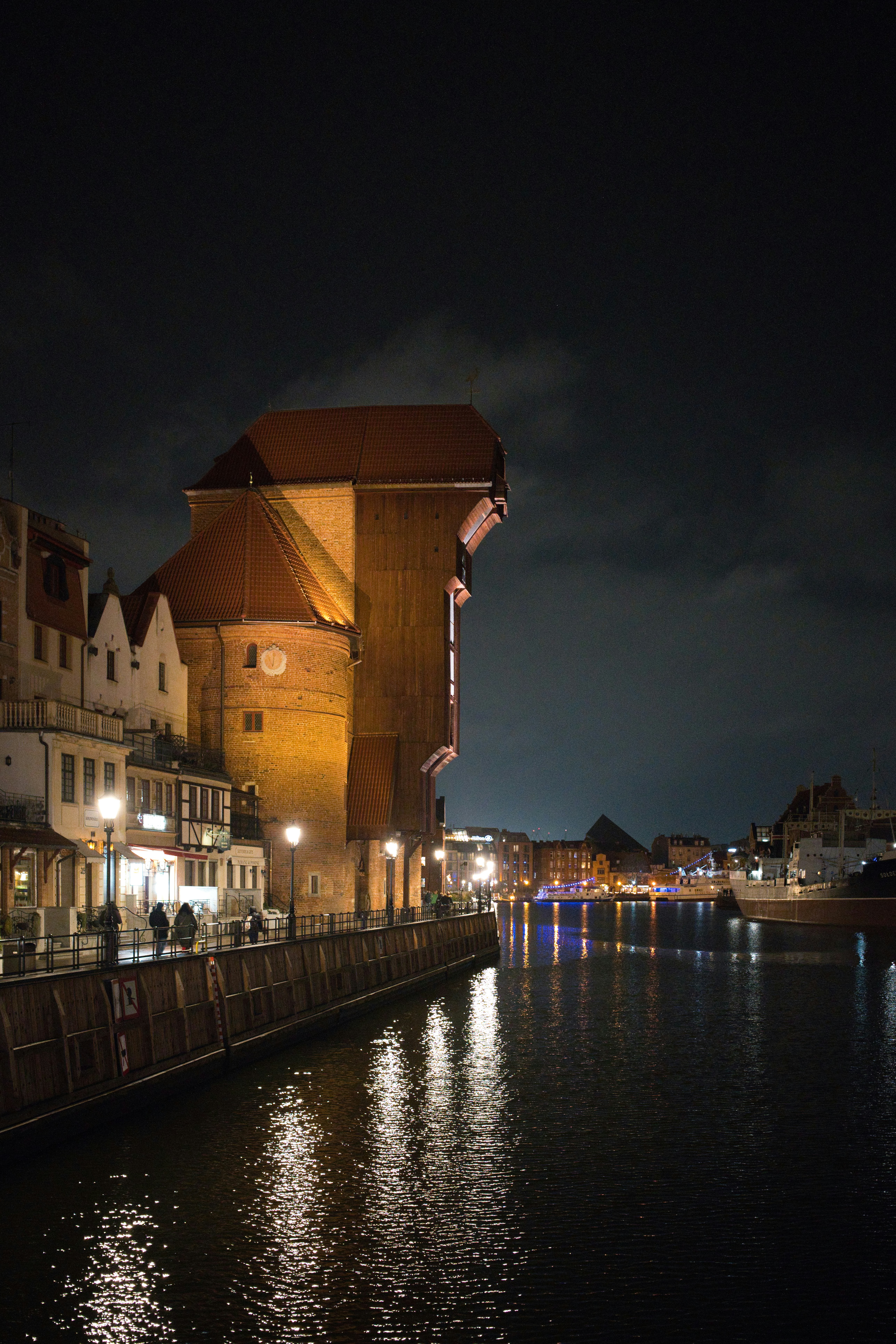 Historic waterfront buildings illuminated at night