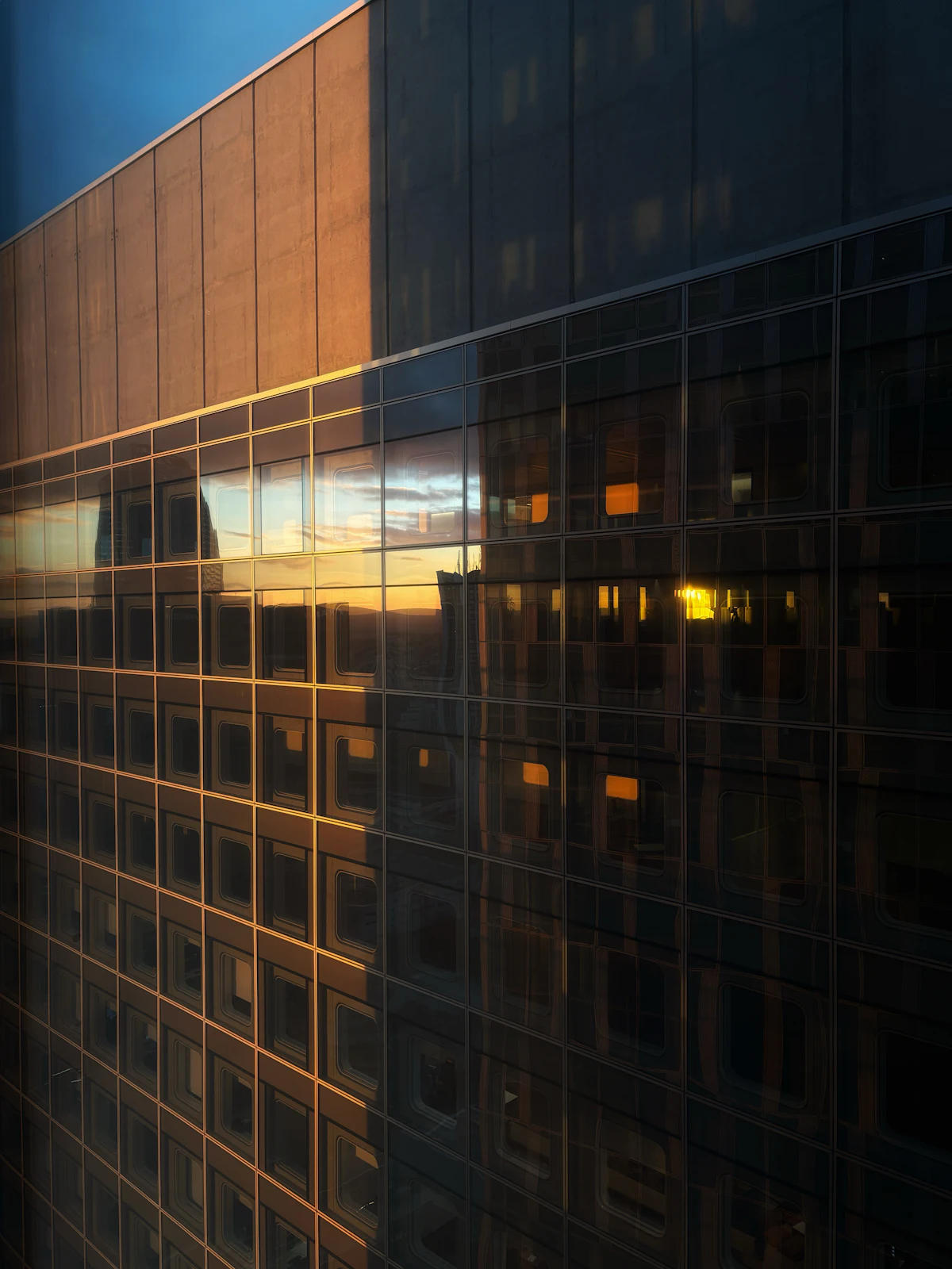 Modern building facade reflecting sunset light