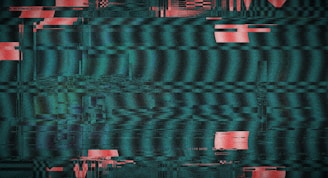 Glitchy television screen with red and teal static.
