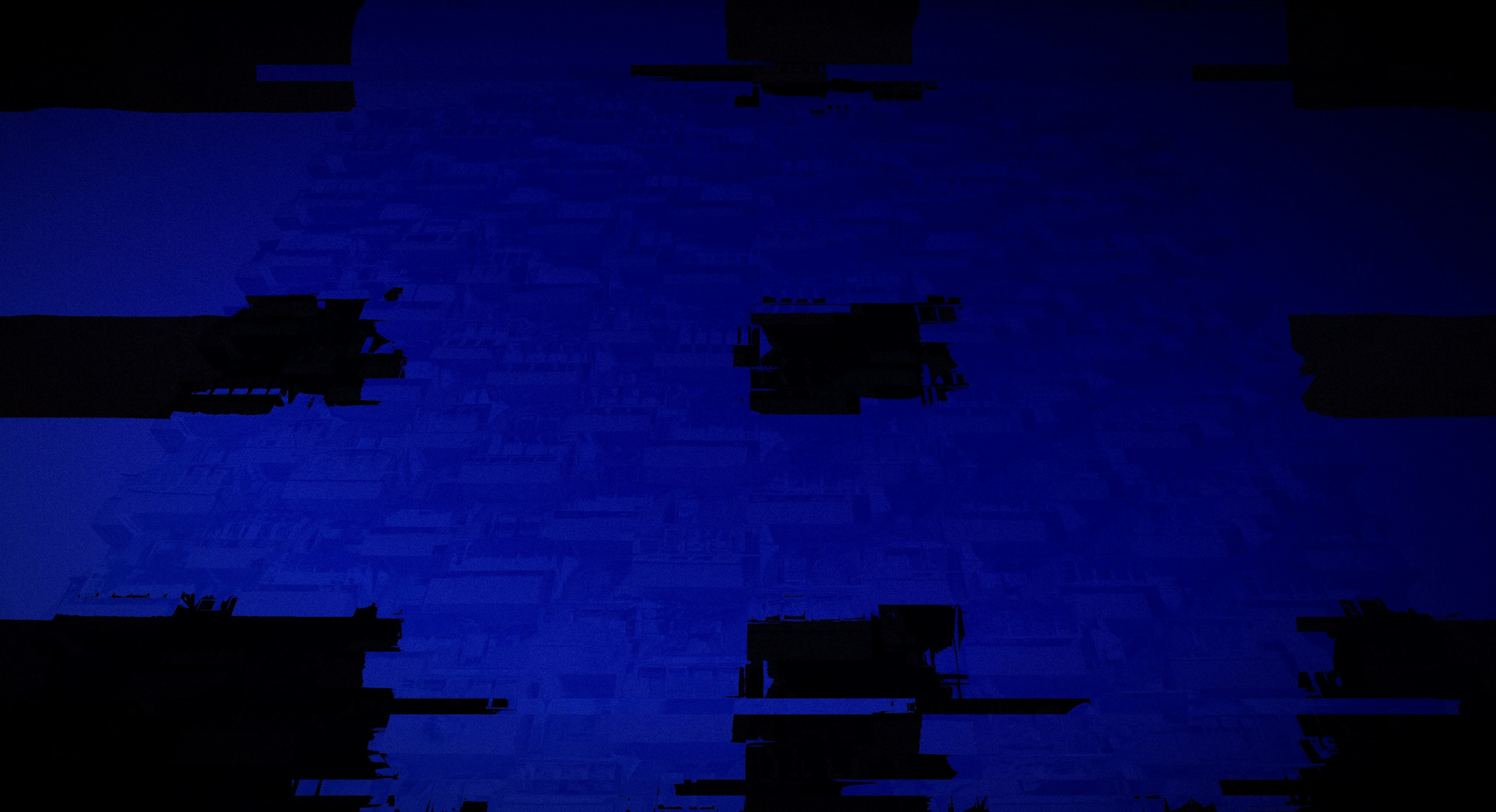 A glitchy abstract blue background with dark squares.