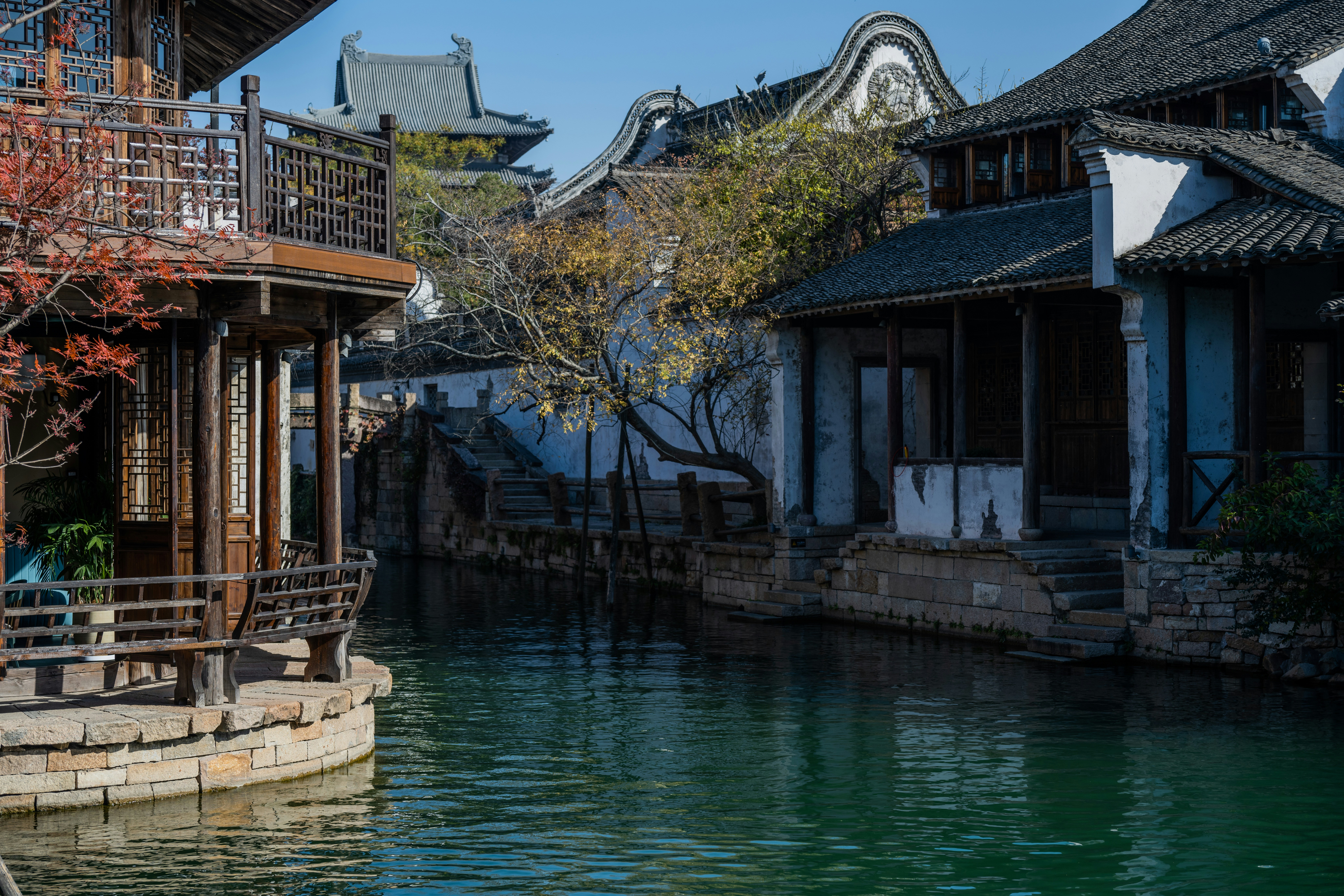 Traditional chinese canal houses with autumn foliage.